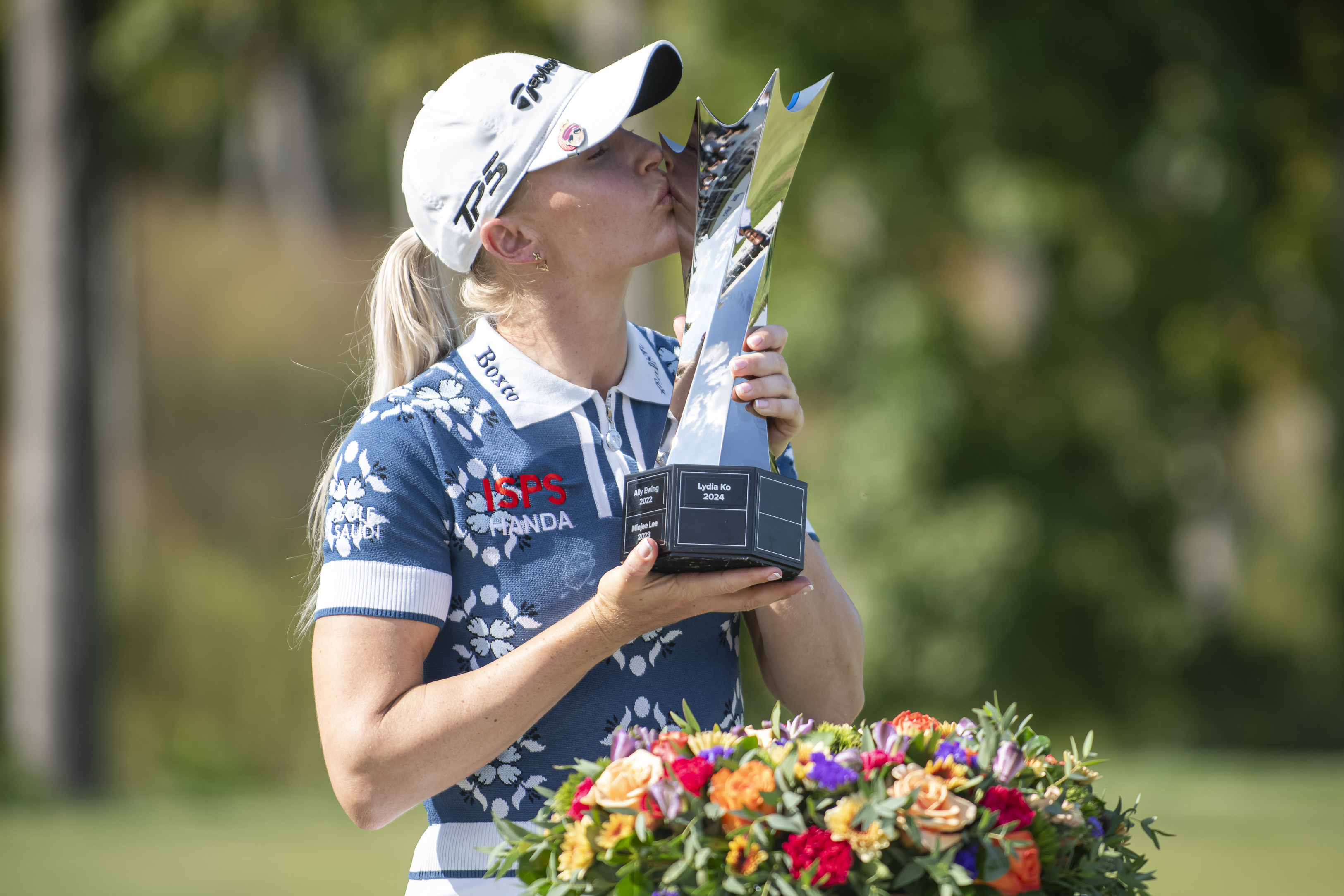 Charley Hull, of England, kisses the trophy after winning the Kroger Queen City Championship golf tournament, Sunday, Sept. 14, 2025, at TPC River's Bend in Cincinnati. 