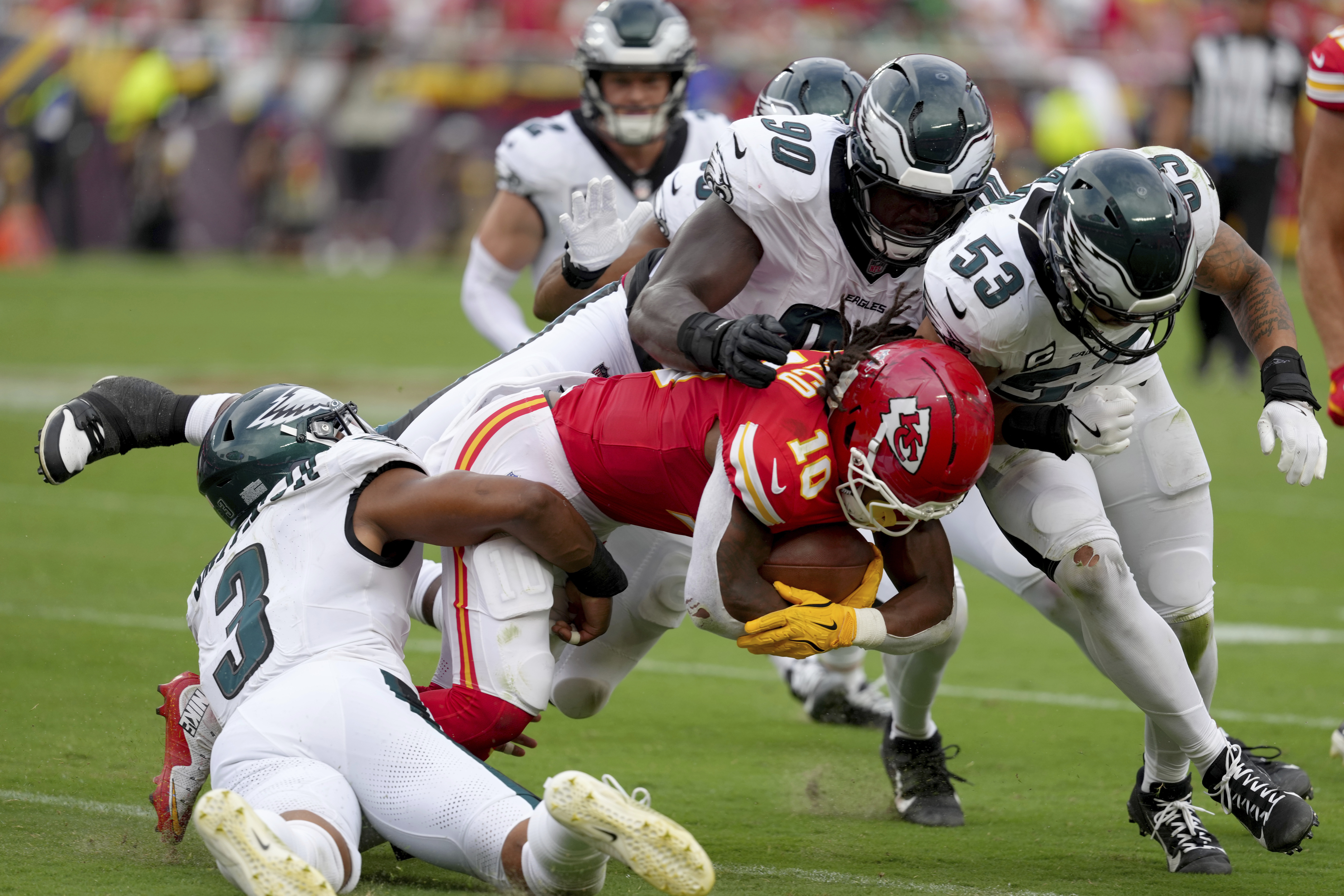 Kansas City Chiefs running back Isiah Pacheco (10) is tackled by Philadelphia Eagles' Nolan Smith (3), Jordan Davis (90) and Zack Baun (53) during the second half of an NFL football game Sunday, Sept. 14, 2025, in Kansas City, Mo. 