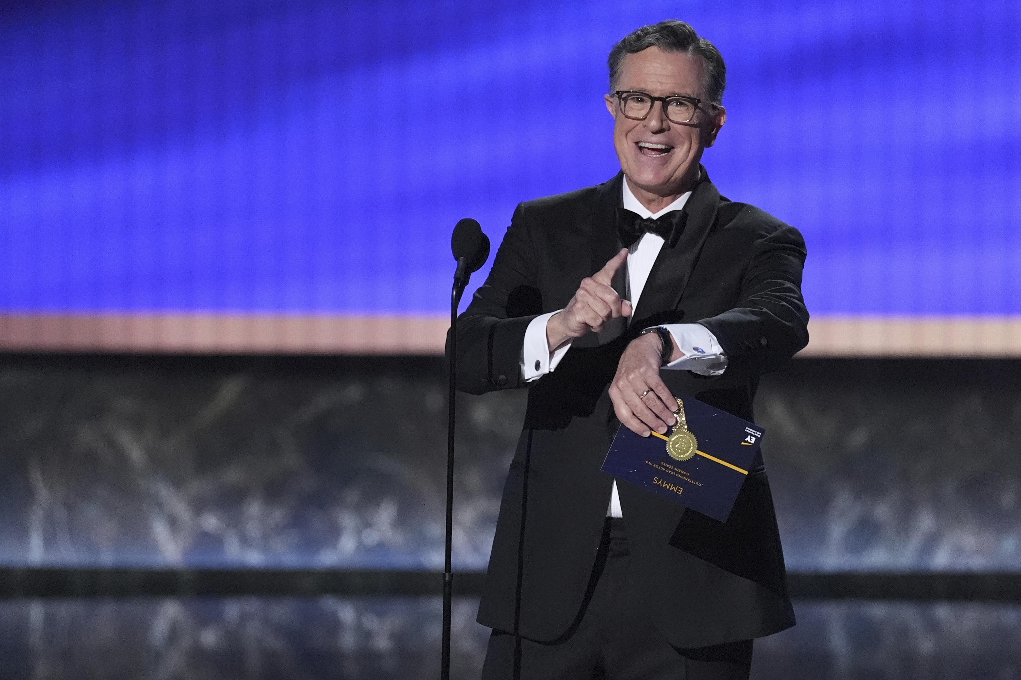 Stephen Colbert presents the award for outstanding lead actor in a comedy series during the 77th Primetime Emmy Awards on Sunday, at the Peacock Theater in Los Angeles.