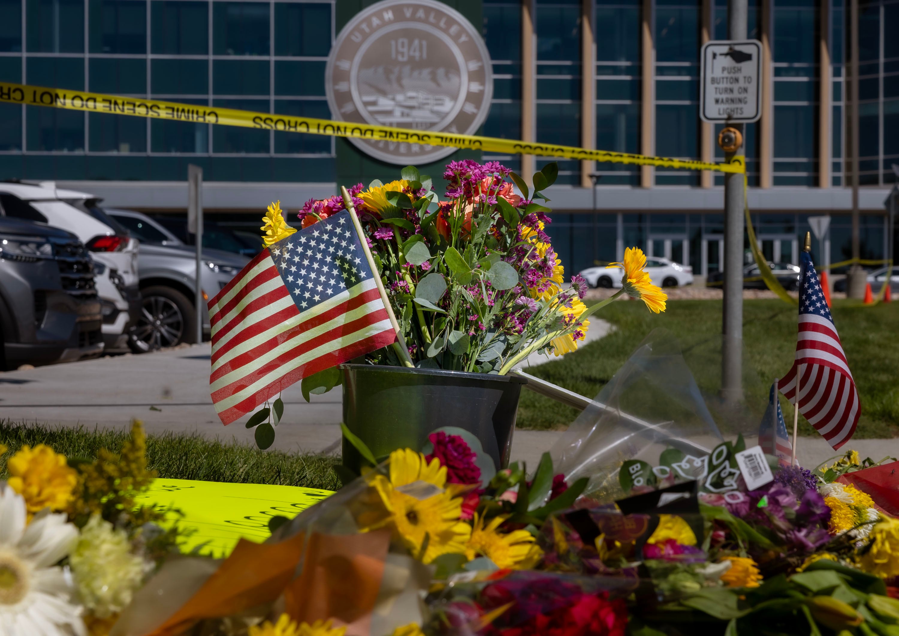 Messages, flowers and American flags are placed at Utah Valley University in Orem on Thursday.