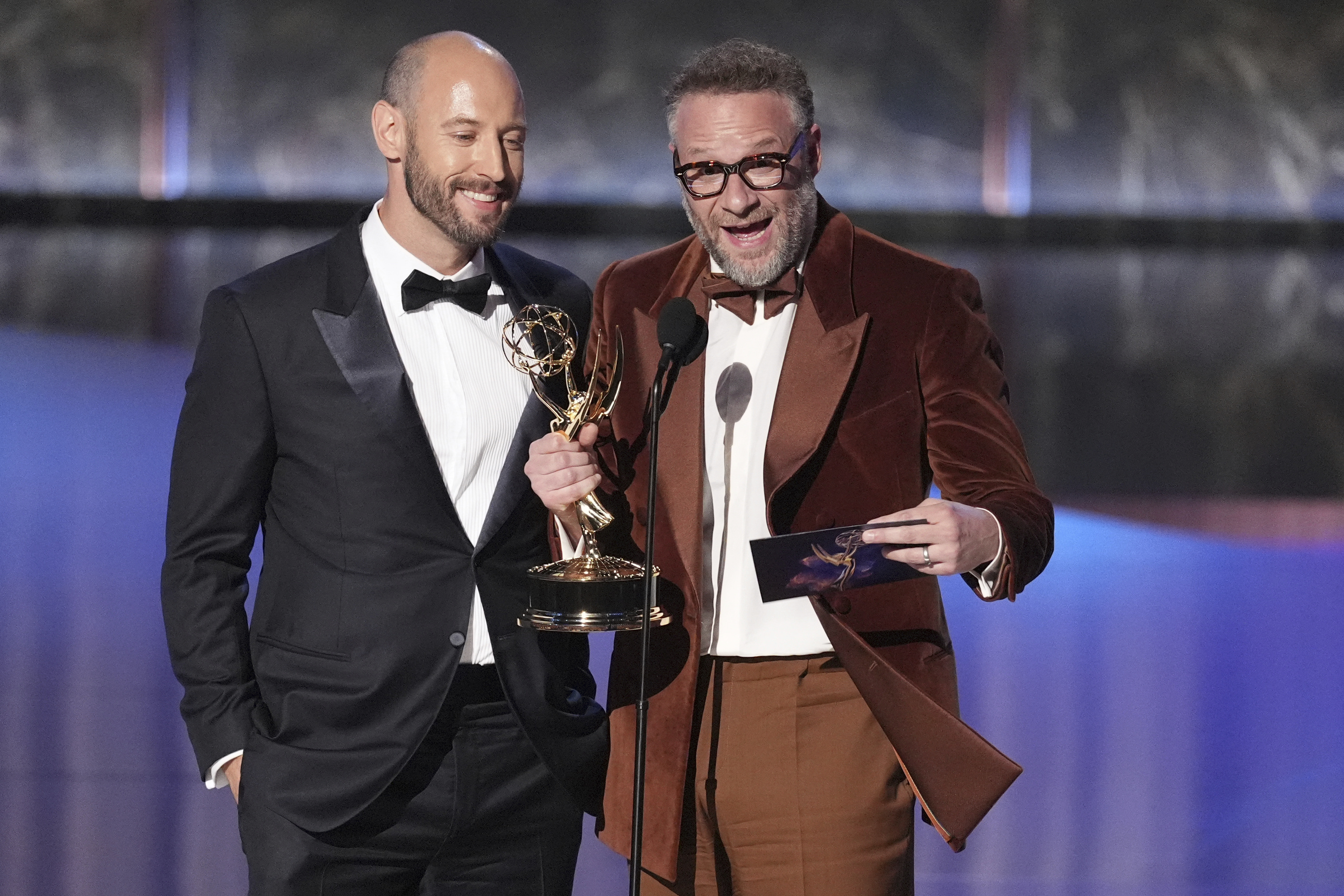 Evan Goldberg, left, and Seth Rogen accept the award for outstanding directing for a comedy series for "The Studio" during the 77th Primetime Emmy Awards on Sunday, at the Peacock Theater in Los Angeles.