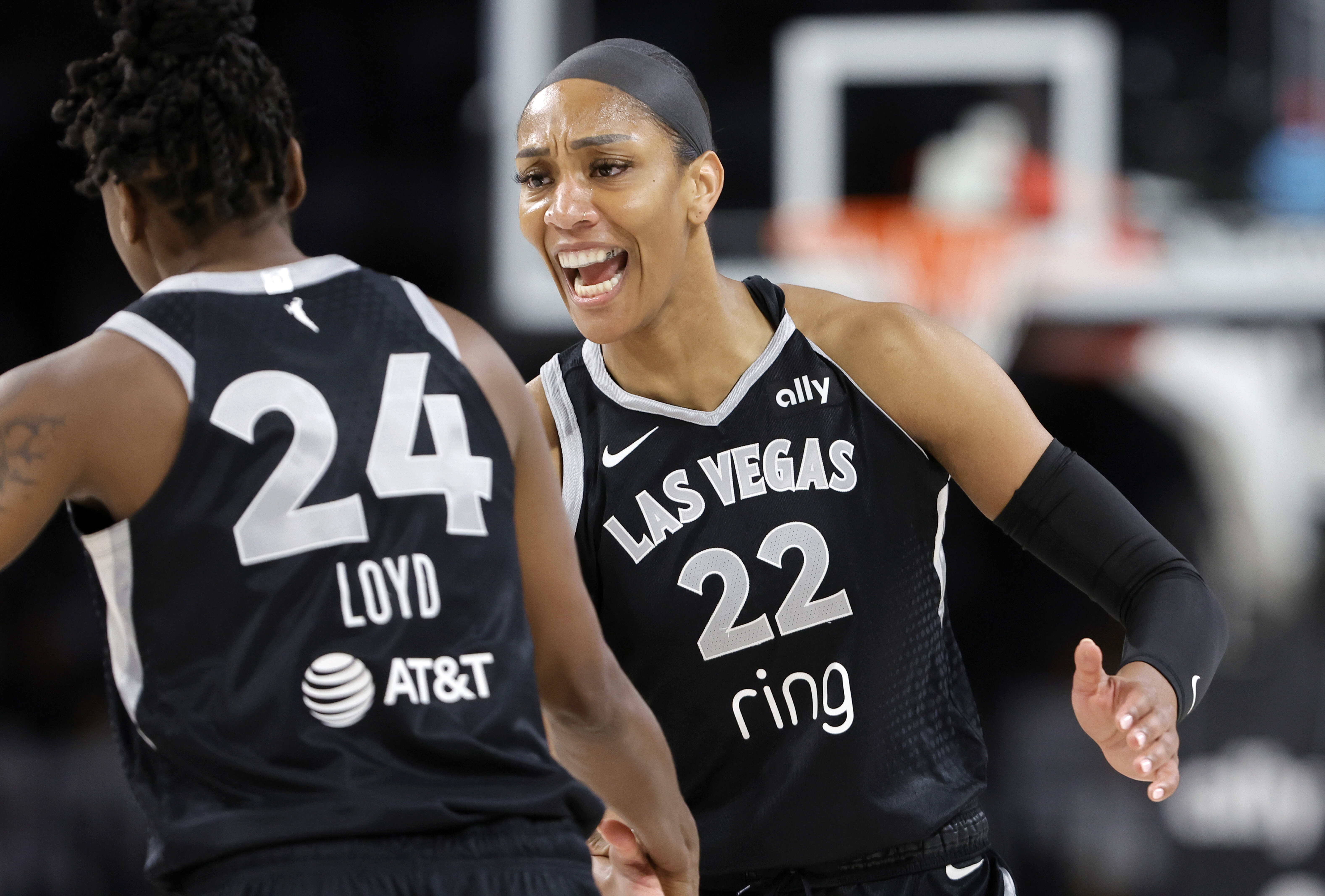 Las Vegas Aces center A'ja Wilson (22) congratulates guard Jewell Loyd (24) after Loyd scored a 3-point basket during the first half of Game 1 against the Seattle Storm in the first round of the WNBA basketball playoffs Sunday, Sept. 14, 2025, in Las Vegas. 