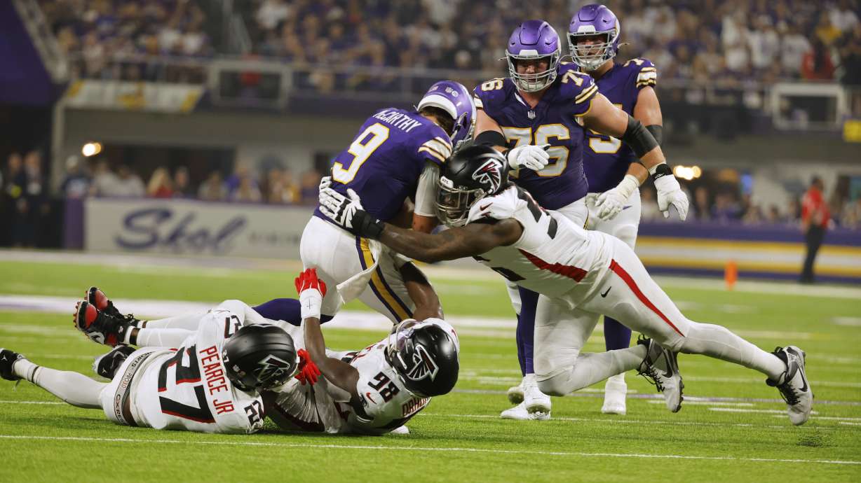 Atlanta Falcons defensive end Zach Harrison (96) sacks Minnesota Vikings quarterback J.J. McCarthy (9) during the first half of an NFL football game, Sunday, Sept. 14, 2025, in Minneapolis.