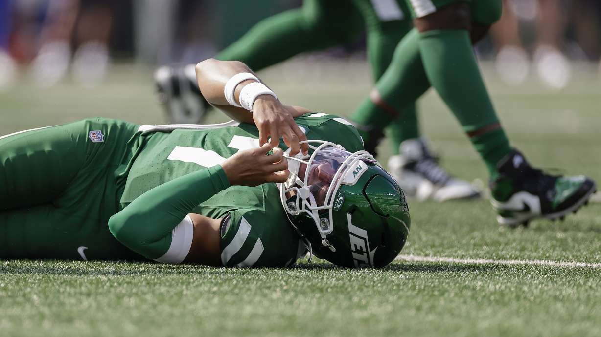 New York Jets quarterback Justin Fields (7) reacts after being sacked by the Buffalo Bills during the fourth quarter of an NFL football game, Sunday, Sept. 14, 2025, in East Rutherford, N.J.