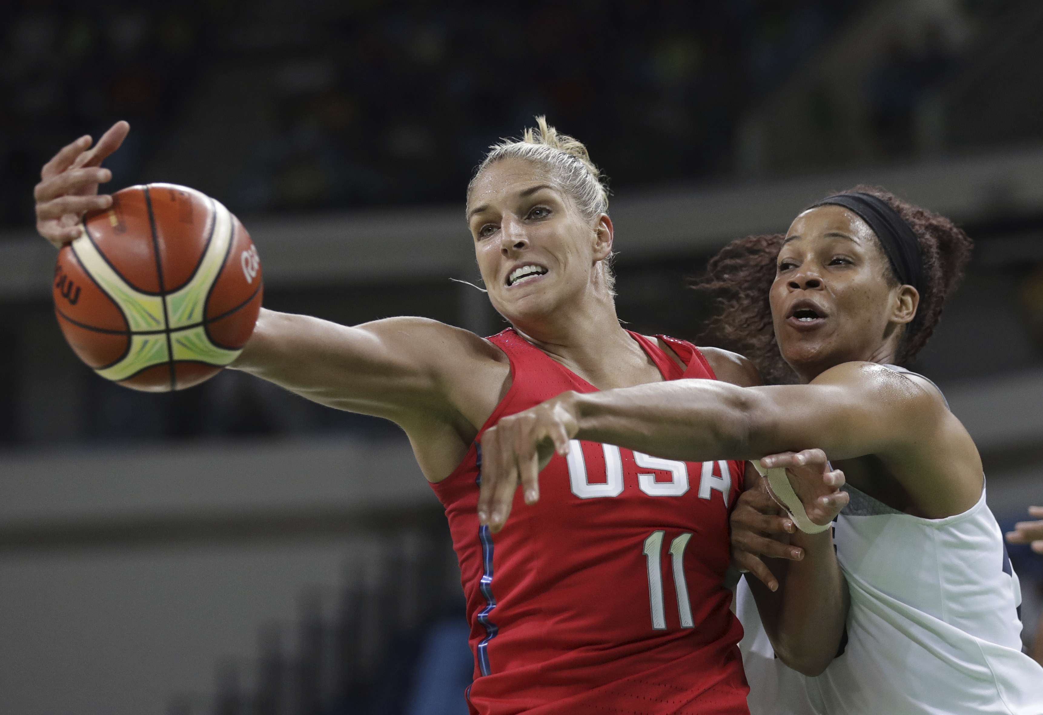 File - This Aug. 18, 2016, file photo shows United States' Elena Delle Donne (11) and France's Marielle Amant, right, reaching out for the ball during a women's semifinal round basketball game at the 2016 Summer Olympics in Rio de Janeiro, Brazil. 
