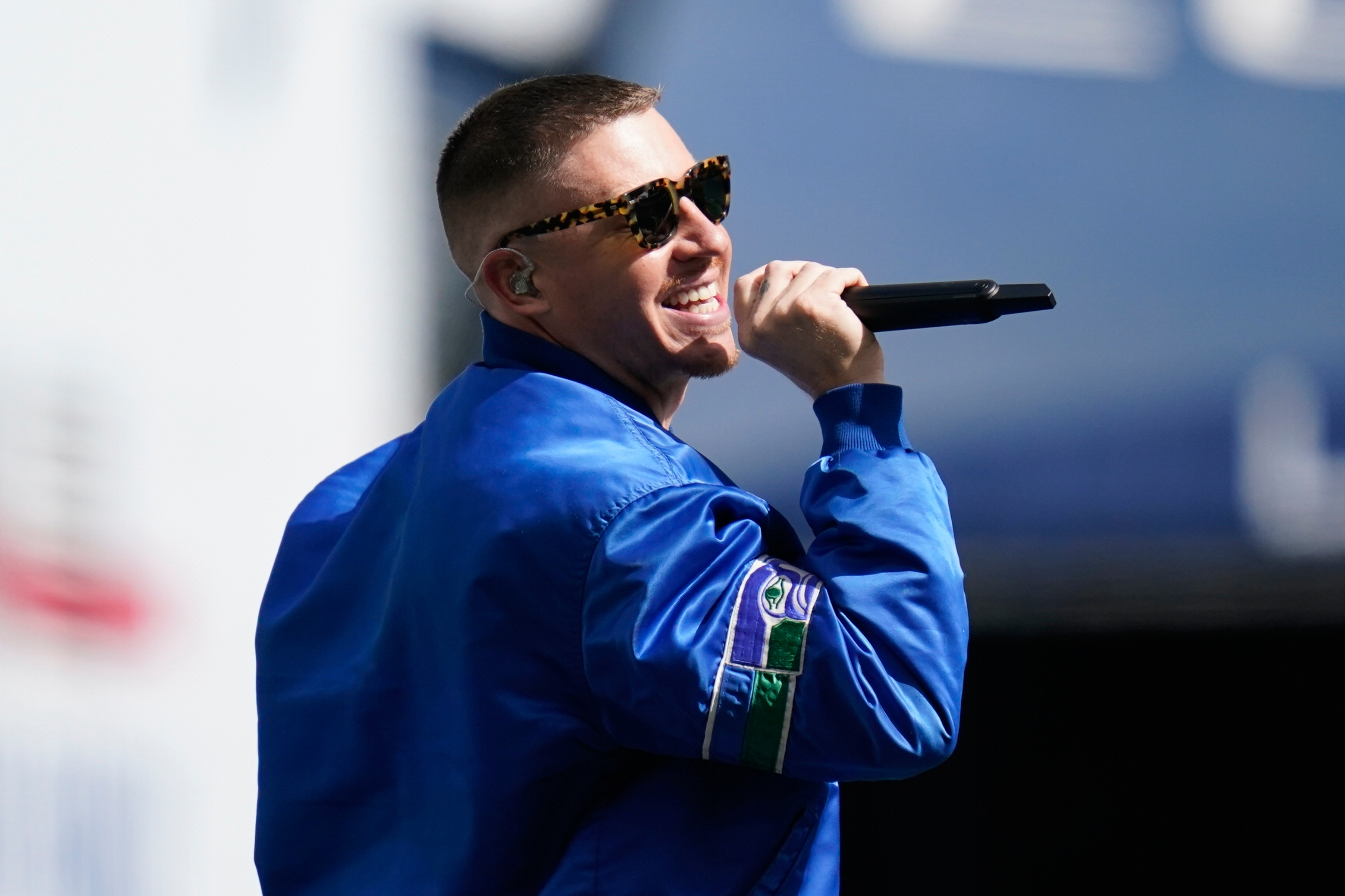 FILE - Rap singer Macklemore performs before an NFL football game between the Seattle Seahawks and the Tennessee Titans, Sept. 19, 2021, in Seattle. 