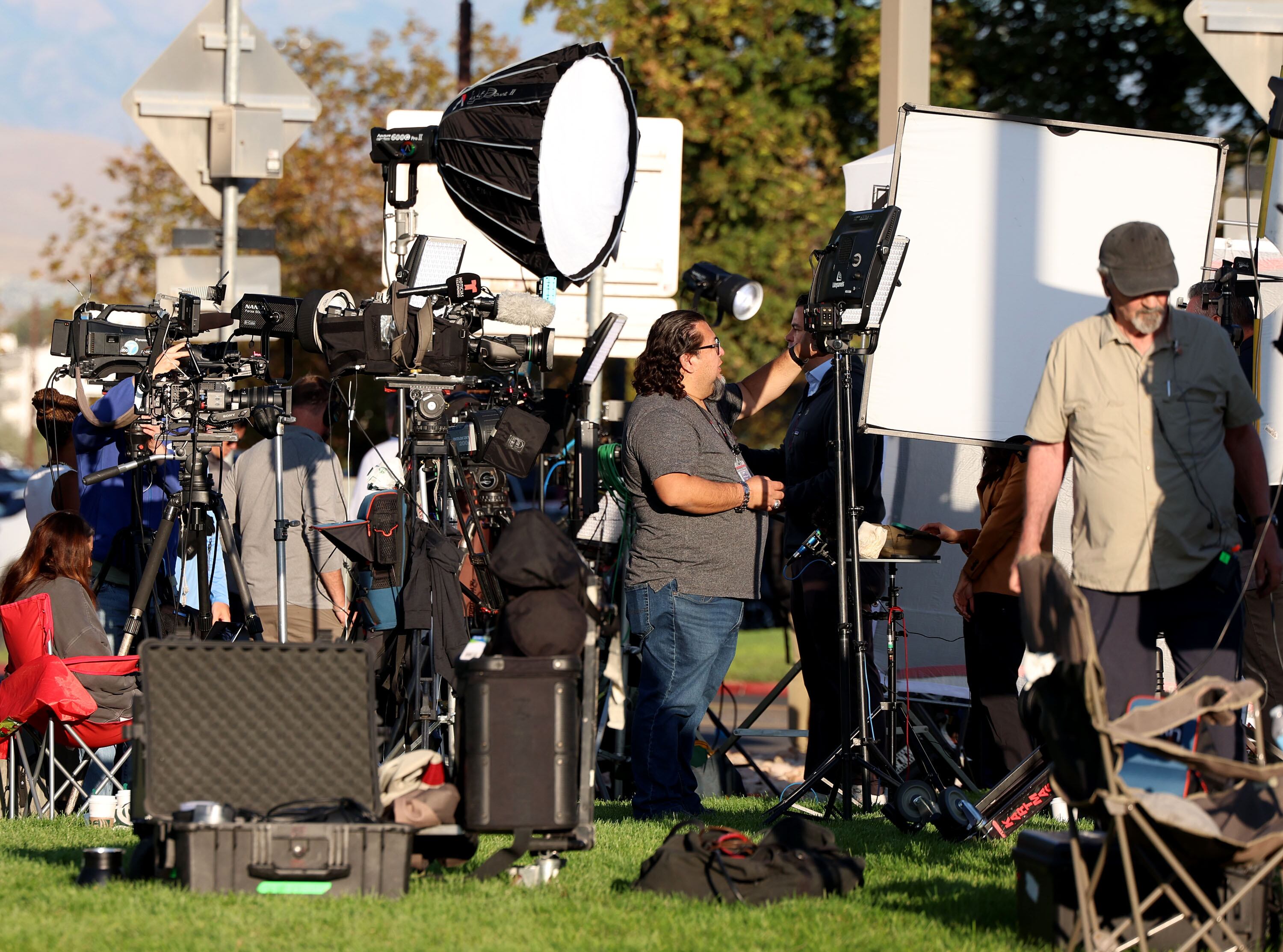 Members of the media work from the Utah Valley University campus in Orem on Sept. 11.