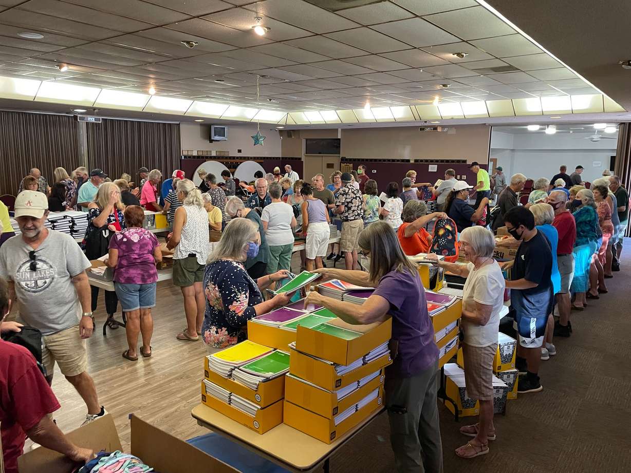 Dozens of volunteers, including some students, joined the Rotary Club of Dixie Sunrise to fill backpacks with donated school supplies for homeless students in the Washington County School District.