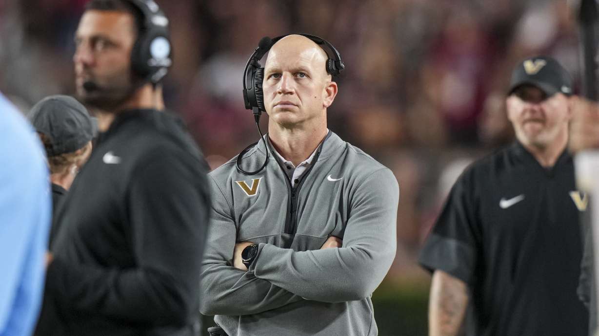 Vanderbilt head coach Clark Lea, center, watches the action from the sideline in the second half of an NCAA college football game against South Carolina, Saturday, Sept. 13, 2025, in Columbia, S.C.