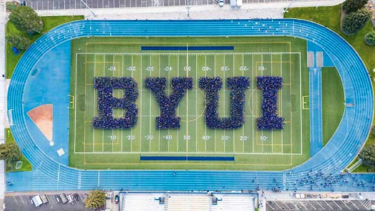 Students stand in formation on the BYU-I football field. Officials reported Monday that the university saw a record enrollment of new students.