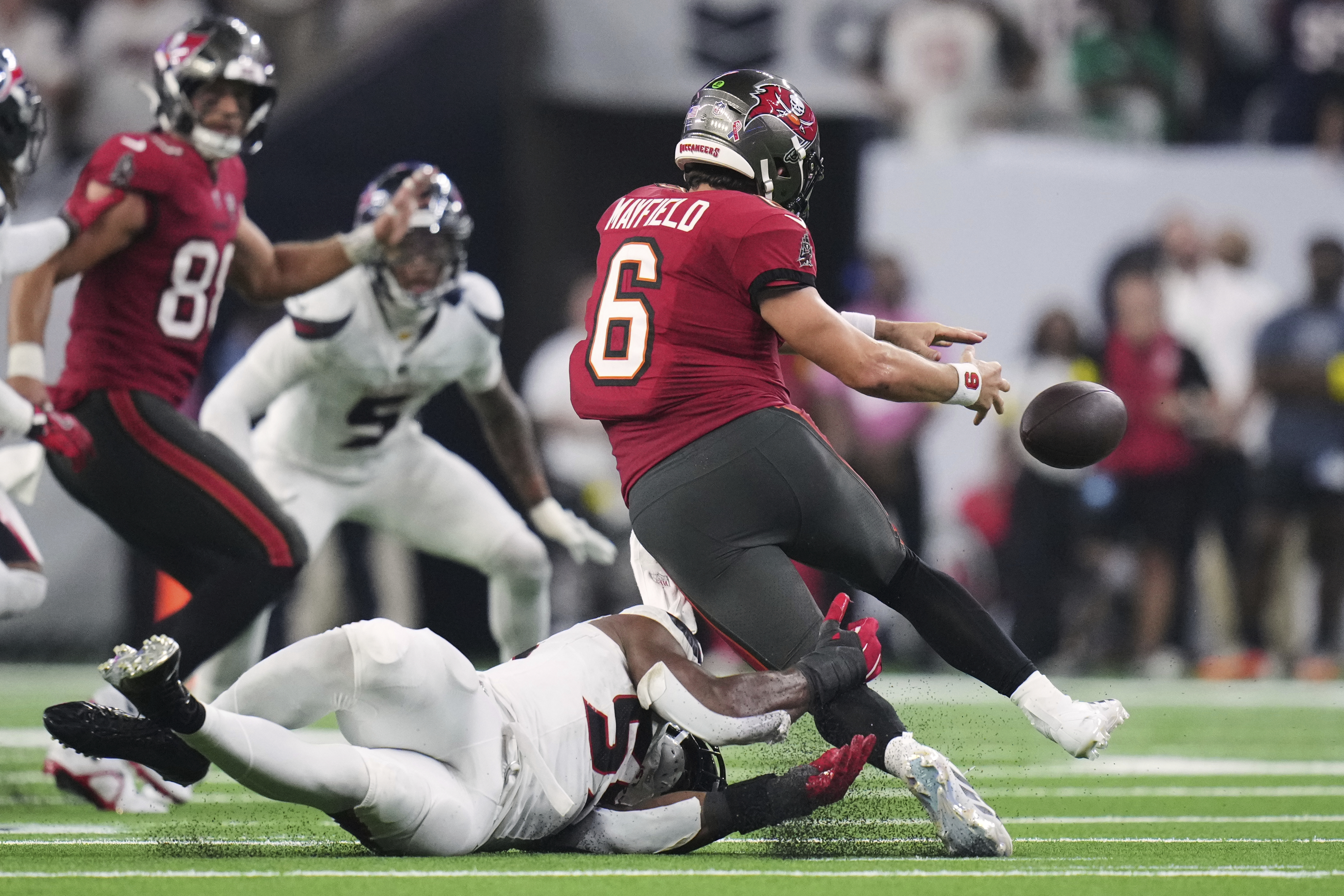 Tampa Bay Buccaneers quarterback Baker Mayfield (6) is stripped of the ball in the second half of an NFL football game against the Houston Texans Monday, Sept. 15, 2025, in Houston, Texas. 