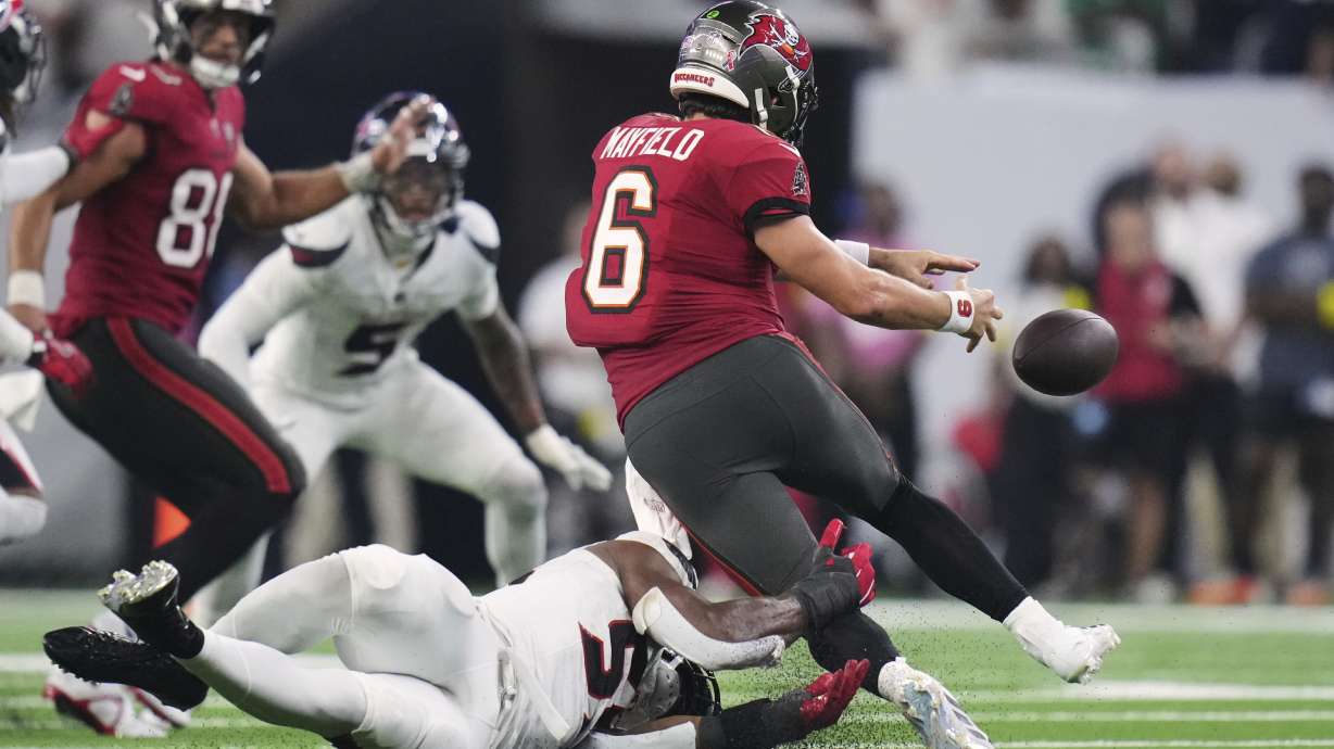 Tampa Bay Buccaneers quarterback Baker Mayfield (6) is stripped of the ball in the second half of an NFL football game against the Houston Texans Monday, Sept. 15, 2025, in Houston, Texas.