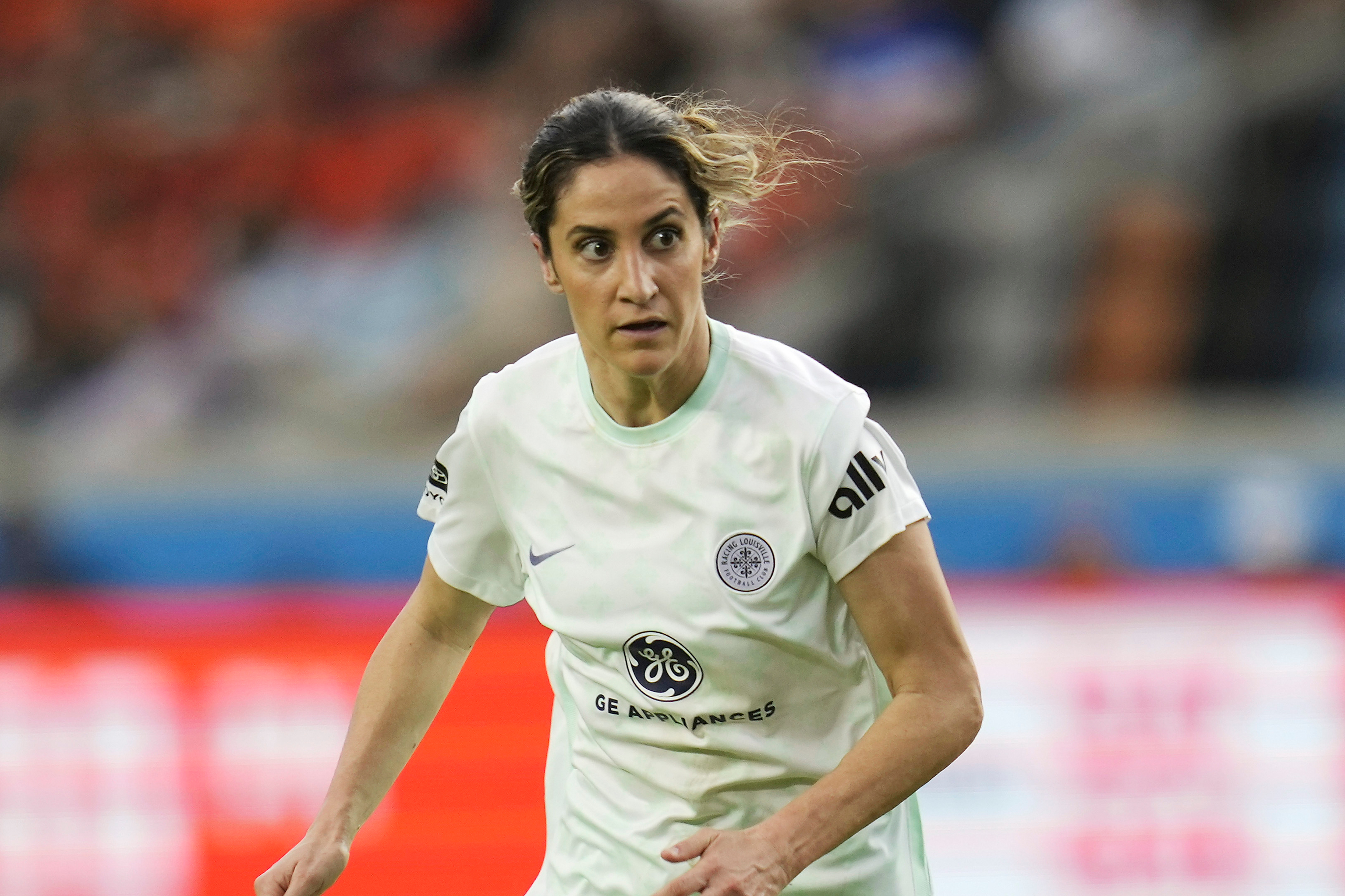 FILE - Racing Louisville FC midfielder Savannah DeMelo (7) looks for a pass against the Houston Dash during an NWSL soccer match, on March 26, 2023, in Houston. 