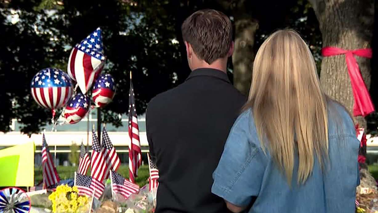 Ike and Kate Niederhauser view a memorial at Utah Valley University on Monday, after last week's shooting of Charlie Kirk on campus. Classes begin Wednesday for Ike, who is a senior.