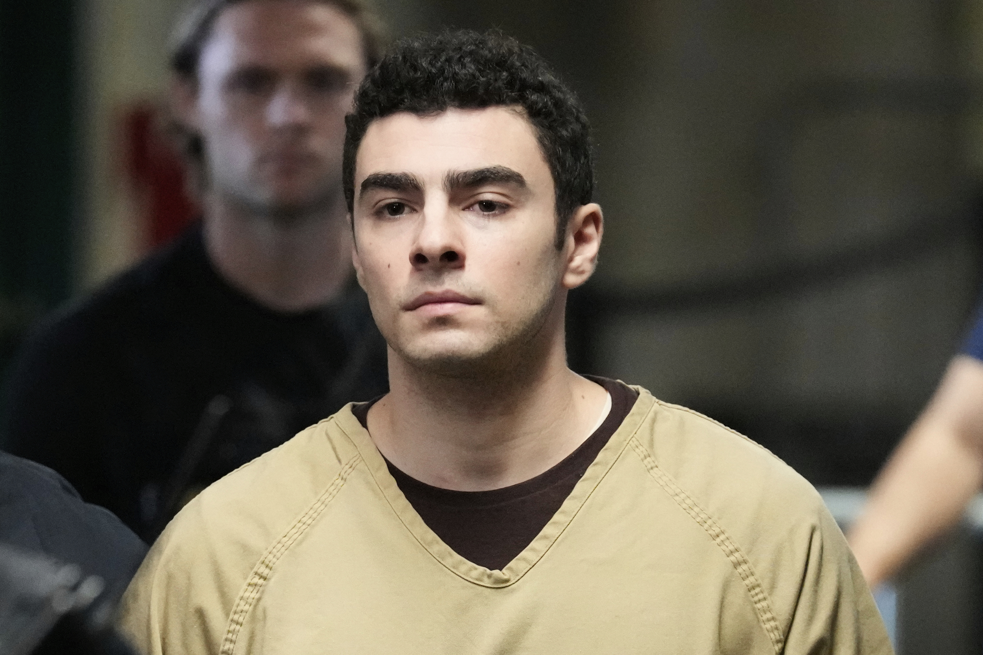 Luigi Mangione is escorted into Manhattan state court in New York, Tuesday.