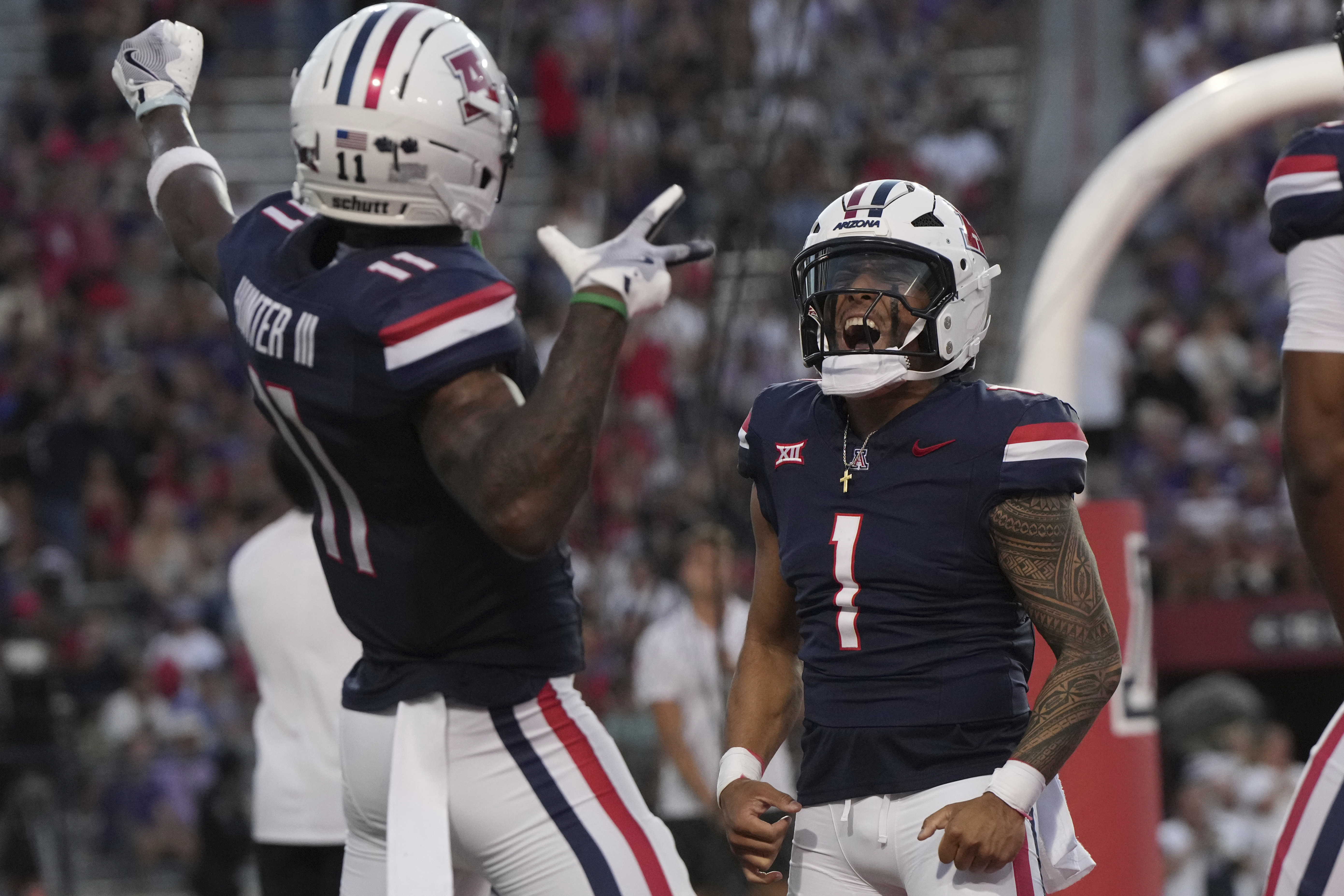 Arizona quarterback Noah Fifita (1) celebrates with wide receiver Chris Hunter, left, after scoring a touchdown against Kansas State in the first half of an NCAA college football game, Friday, Sept 12, 2025, in Tucson, Ariz. 