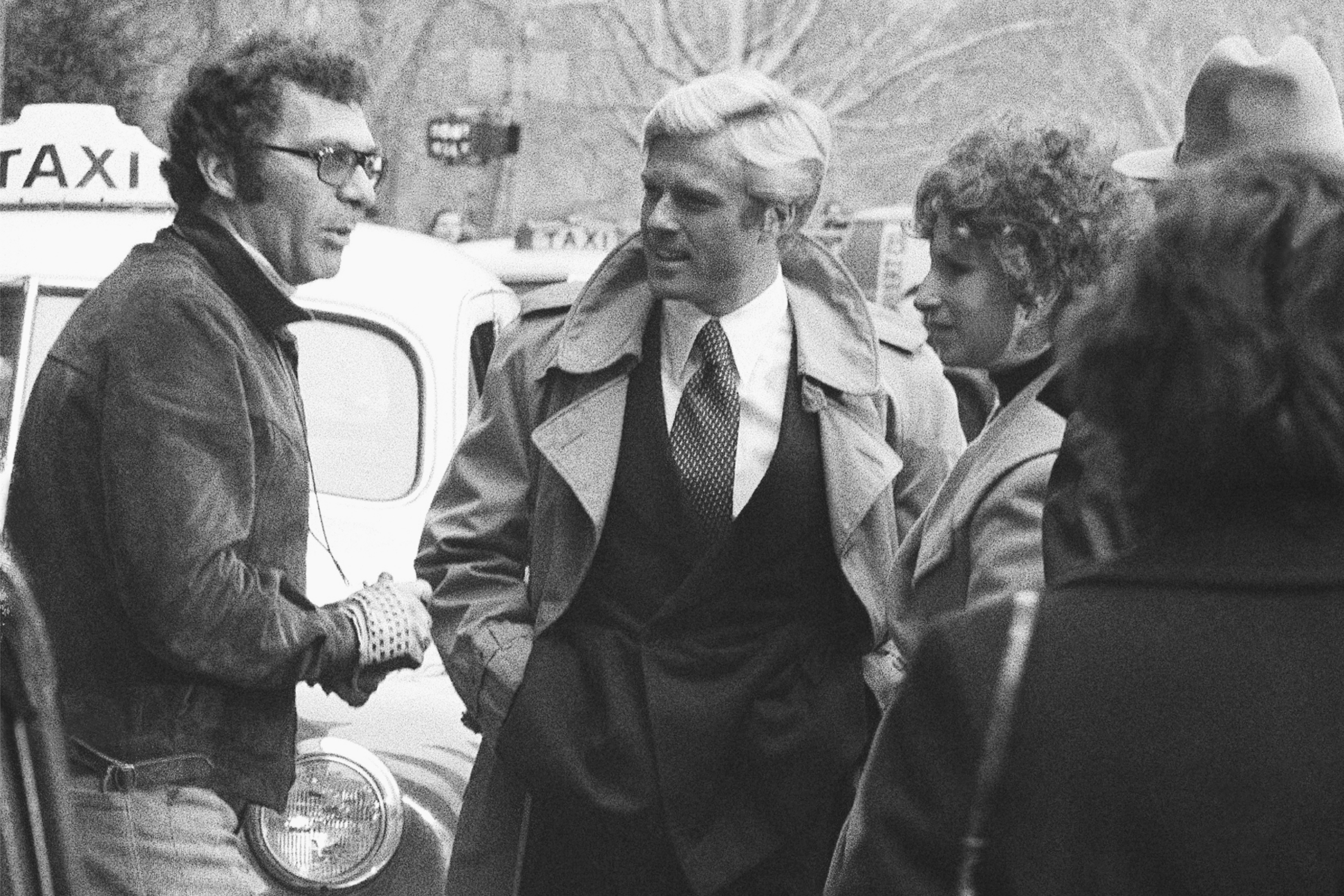 FILE - Director Sydney Pollack, left, appears with actors Robert Redford, center, and Barbra Streisand during the filming of "The Way We Were" in New York on Nov. 28, 1972. 