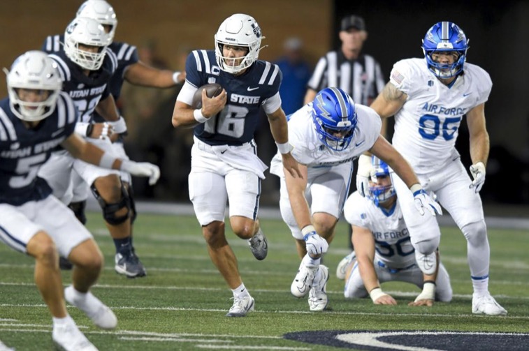 Utah State quarterback Bryson Barnes (16) runs down the field against Air Force in the first half Saturday in Logan.