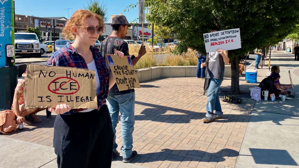 A handful of demonstrators protested U.S. immigration policy outside the site of a Department of Homeland Security job fair at the Utah Valley Convention Center in Provo on Tuesday.