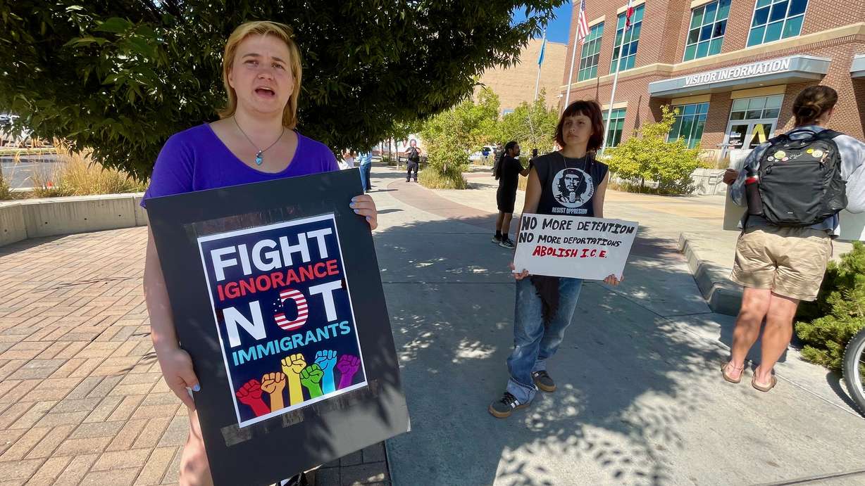 Natassja Grossman, left, and a handful of other demonstrators protested U.S. immigration policy outside the site of a Department of Homeland Security job fair at the Utah Valley Convention Center in Provo on Tuesday.