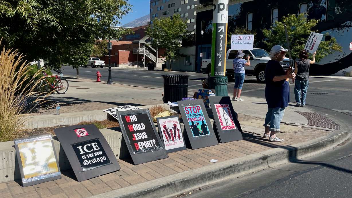 A handful of demonstrators protested U.S. immigration policy outside the site of a Department of Homeland Security job fair at the Utah Valley Convention Center in Provo on Tuesday.