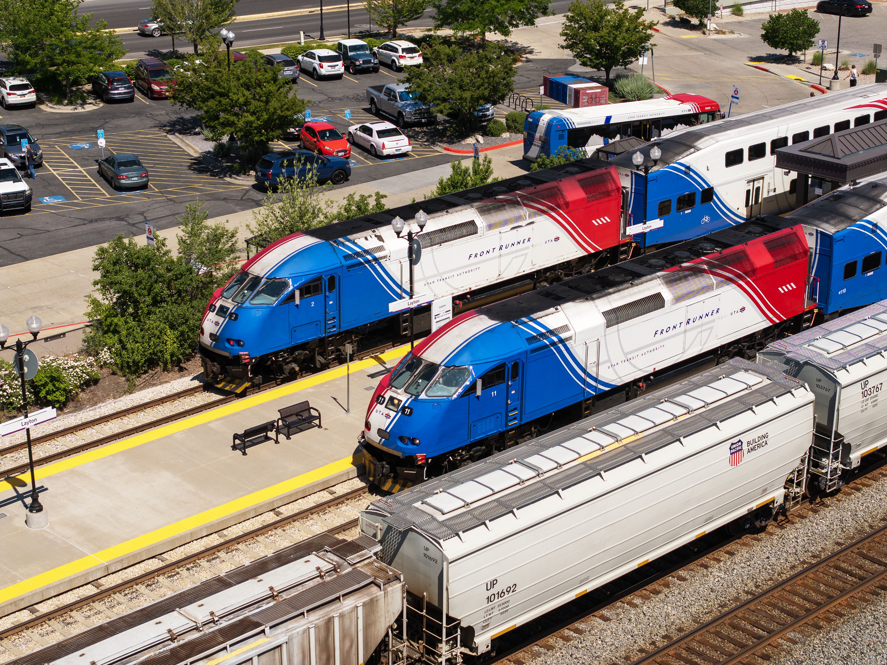 A Union Pacific train passes two FrontRunner trains at the Layton Station on June 3, 2025. Utah leaders are still waiting on a massive grant application to help double-track the commuter rail service, which could be operational by 2030.