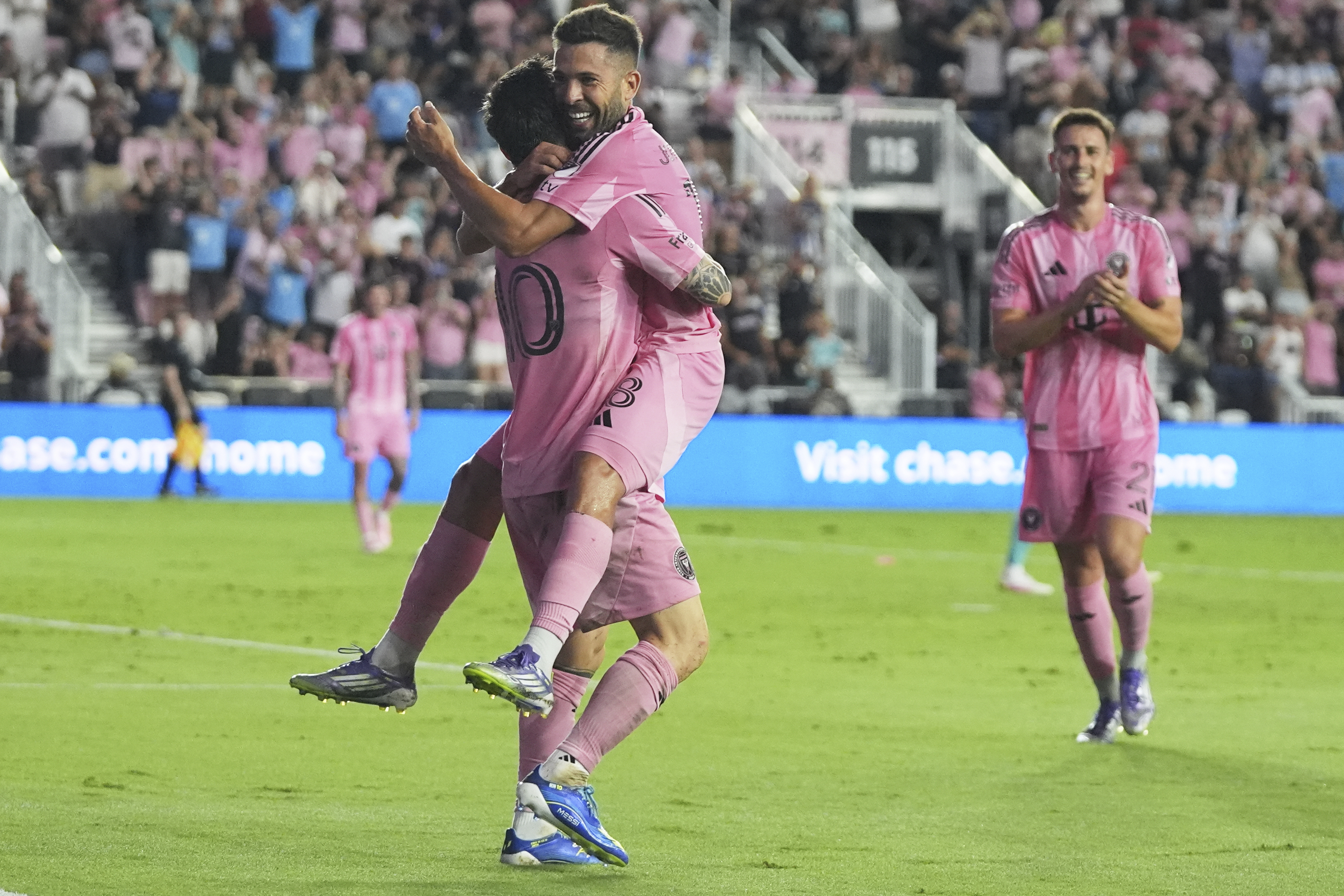 Inter Miami forward Lionel Messi, left, celebrates with defender Jordi Alba, right, after scoring a goal during the first half of an MLS soccer match against Seattle Sounders, Tuesday, Sept. 16, 2025, in Fort Lauderdale, Fla. 