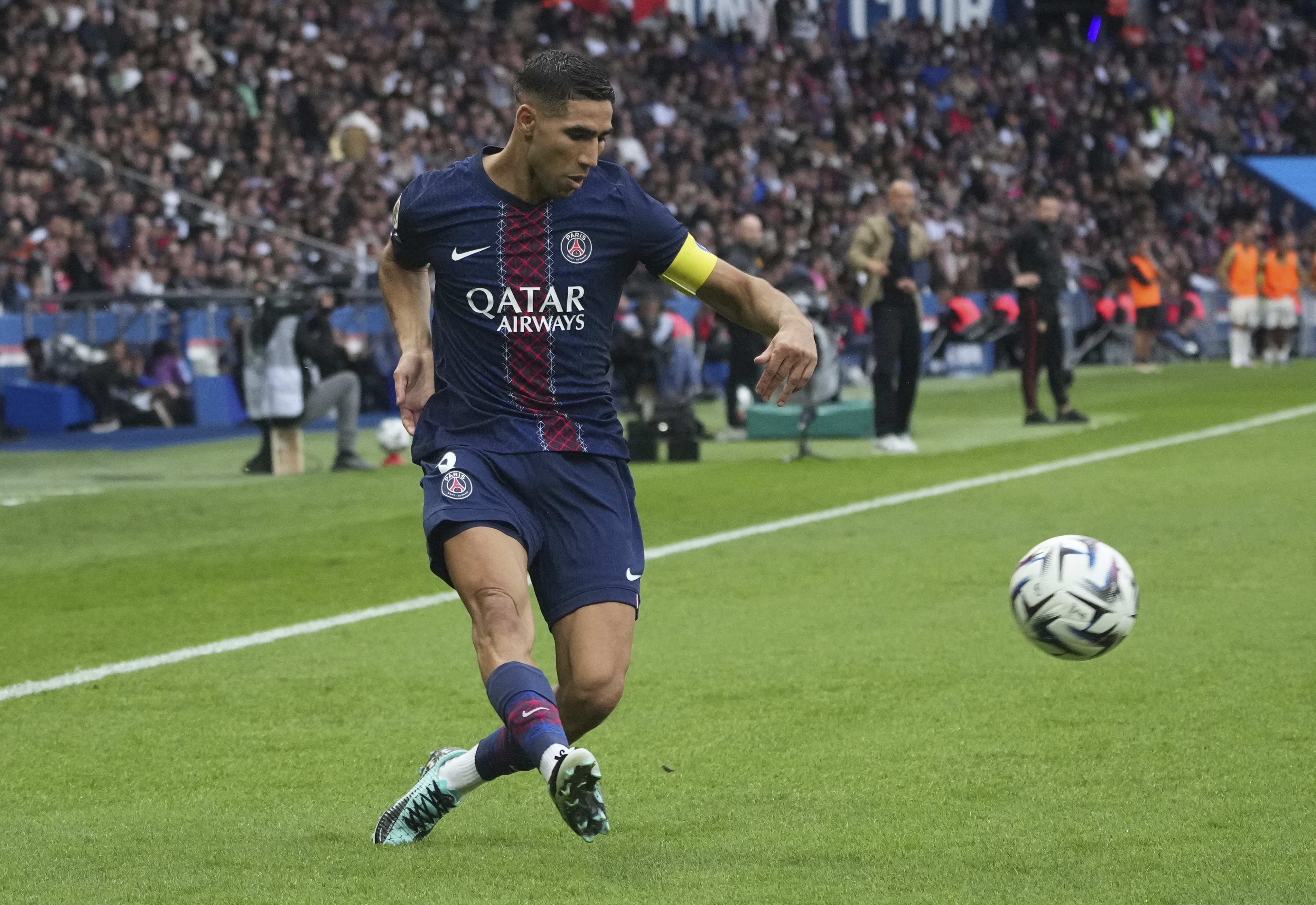 PSG's Achraf Hakimi plays the ball during the French League One soccer match between Paris Saint-Germain and Lens at the Parc des Princes stadium in Paris, Sunday, Sept. 14, 2025. 