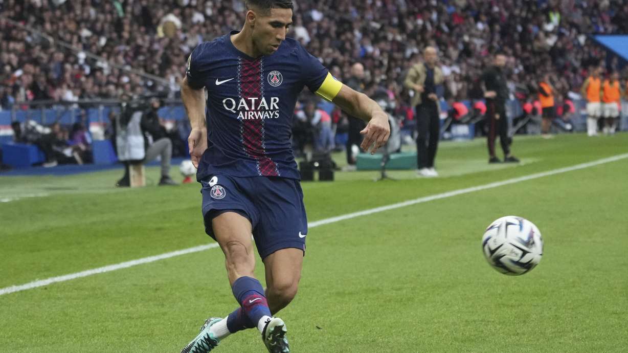 PSG's Achraf Hakimi plays the ball during the French League One soccer match between Paris Saint-Germain and Lens at the Parc des Princes stadium in Paris, Sunday, Sept. 14, 2025.