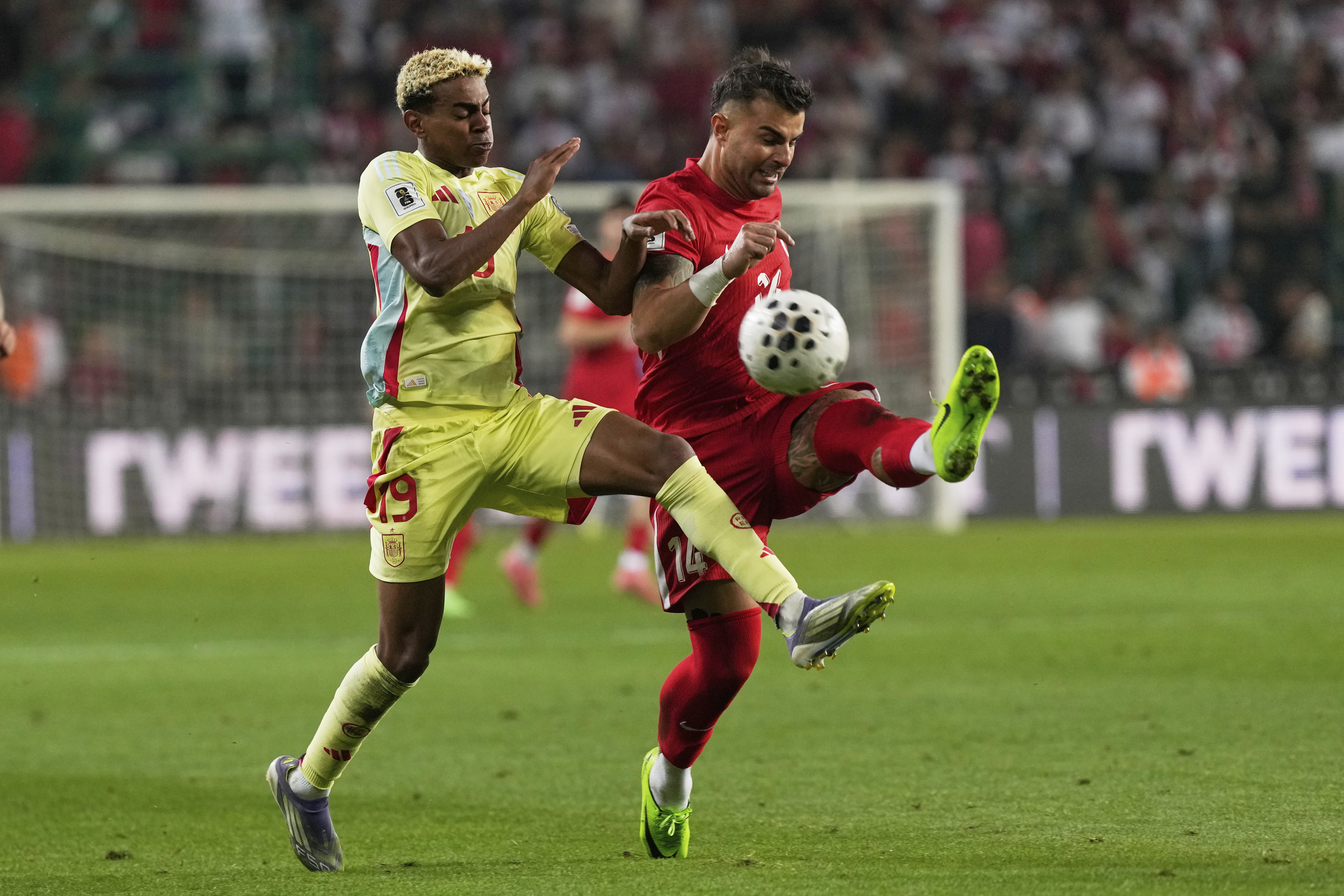 Spain's Lamine Yamal, left, and Turkey's Abdulkerim Bardakci fight for the ball during a World Cup qualifying round Group E soccer match between Turkey and Spain at Konya Buyuksehir stadium, in Konya, Turkey, Sunday, Sept. 7, 2025. 