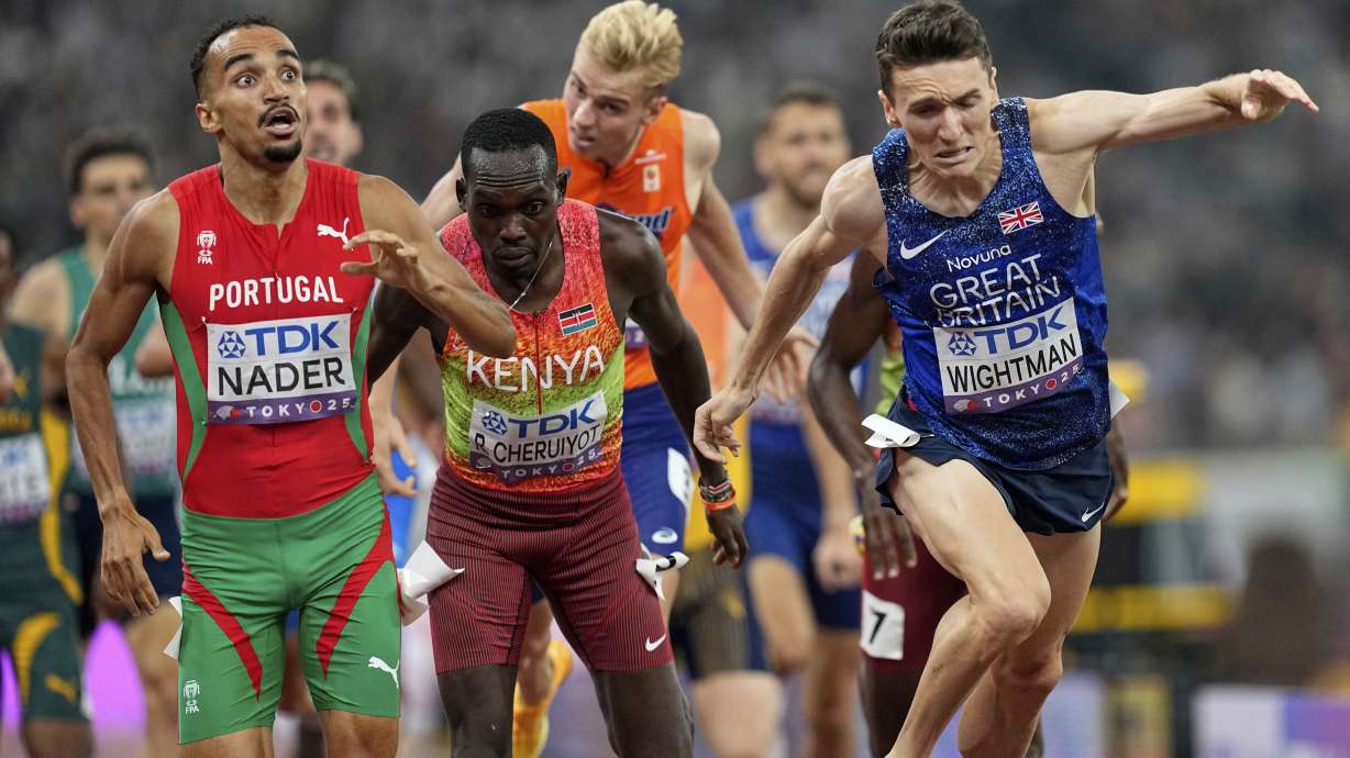 Portugal's Isaac Nader celebrates after winning the gold medal ahead of Britain's Jake Wightman in the men's 1,500 meters final at the World Athletics Championships in Tokyo, Wednesday, Sept. 17, 2025.