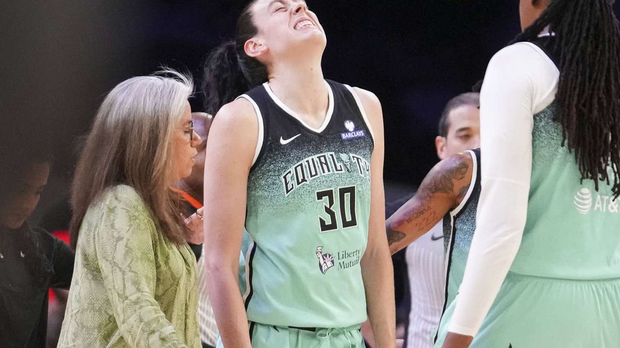 New York Liberty forward Breanna Stewart (30) grimaces after getting fouled by the Phoenix Mercury during the second half of Game 1 during the first round of the WNBA basketball playoffs Sunday, Sept. 14, 2025, in Phoenix.