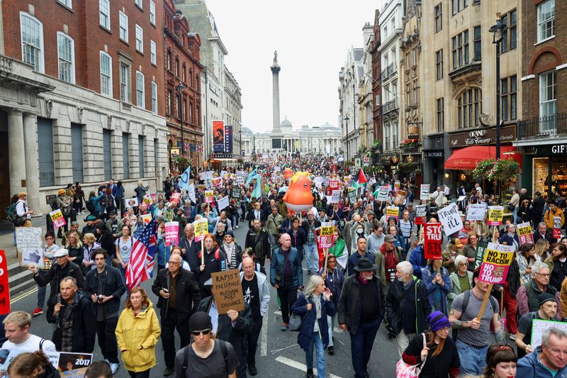 People take part in a protest during the state visit of President Donald Trump in London, Wednesday. A massive security detail is following Trump during his visit.