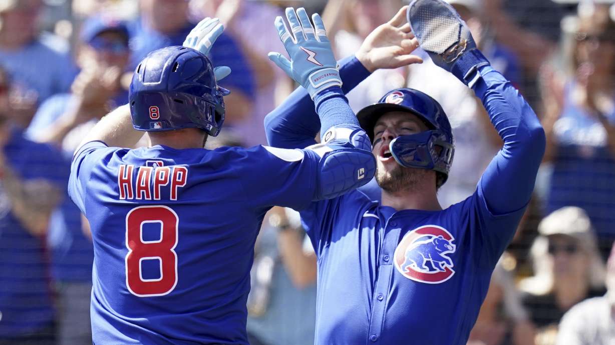 Chicago Cubs' Ian Happ, left, is greeted by Nico Hoerner, right, after hitting a two-run home run during the first inning of a baseball game against the Pittsburgh Pirates, Wednesday, Sept. 17, 2025, in Pittsburgh.