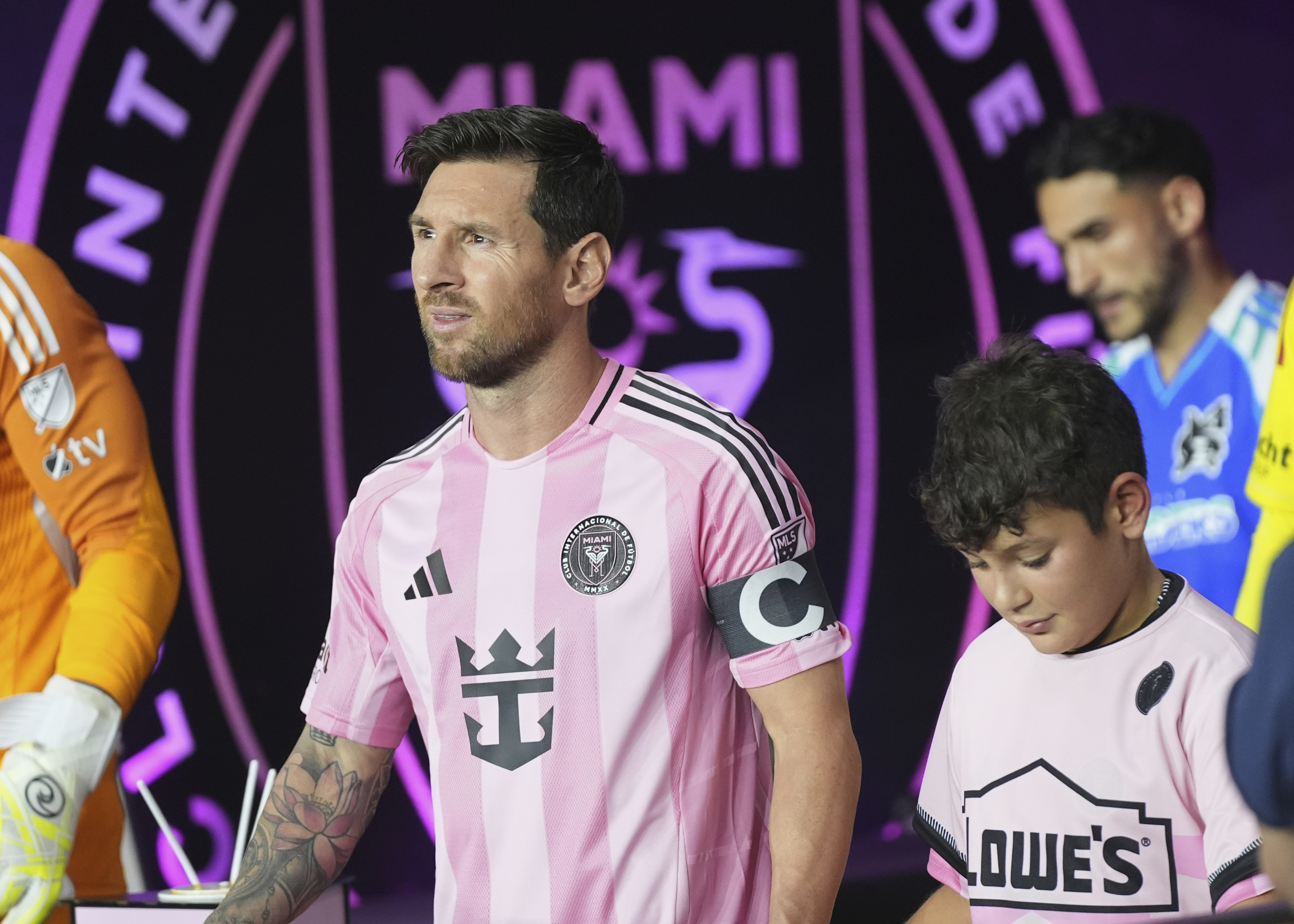 Inter Miami forward Lionel Messi, left, walks onto the field before an MLS soccer match against the Seattle Sounders, Tuesday, Sept. 16, 2025, in Fort Lauderdale, Fla. 