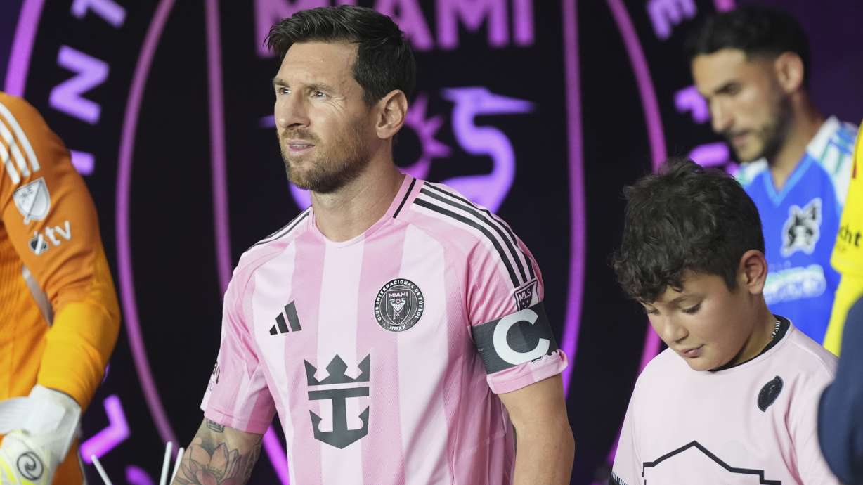 Inter Miami forward Lionel Messi, left, walks onto the field before an MLS soccer match against the Seattle Sounders, Tuesday, Sept. 16, 2025, in Fort Lauderdale, Fla.
