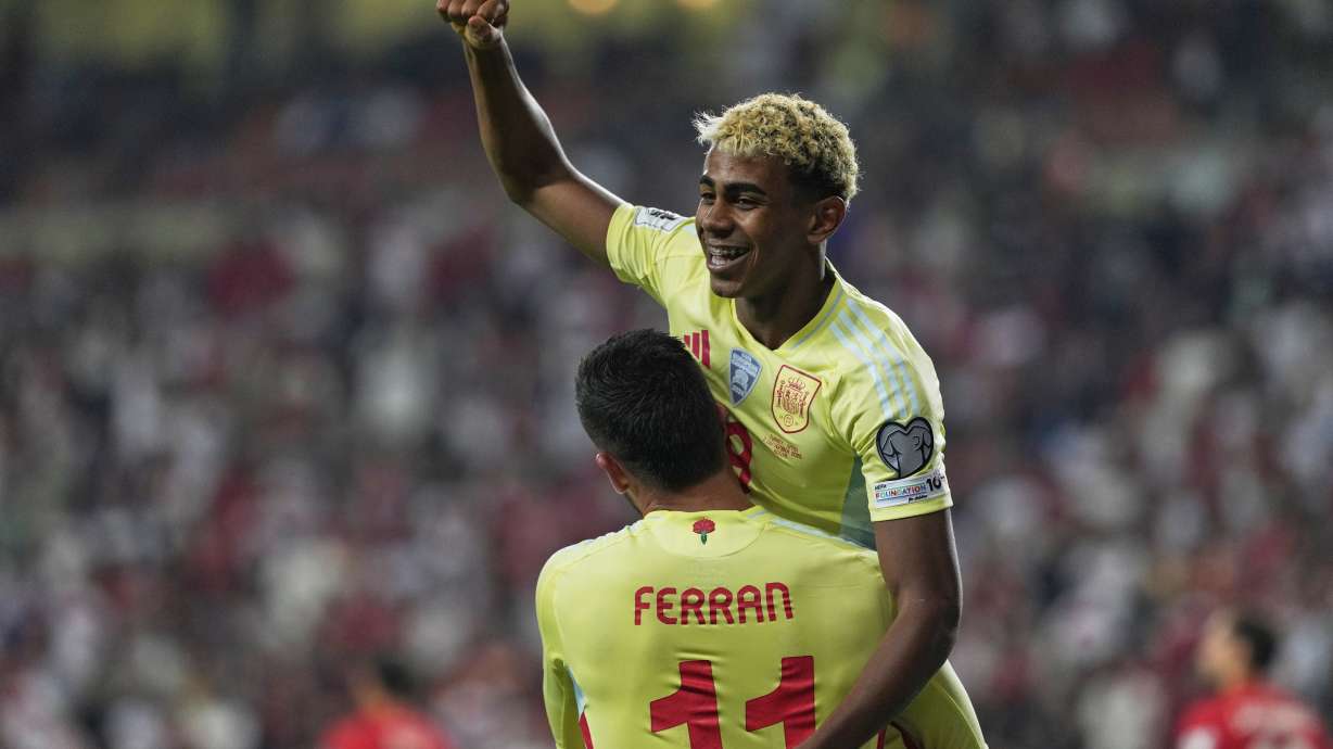 Spain's Ferran Torres, bottom, is congratulated by Lamine Yamal after scoring his side's 4th goal during a World Cup qualifying round Group E soccer match between Turkey and Spain at Konya Buyuksehir stadium, in Konya, Turkey, Sunday, Sept. 7, 2025.