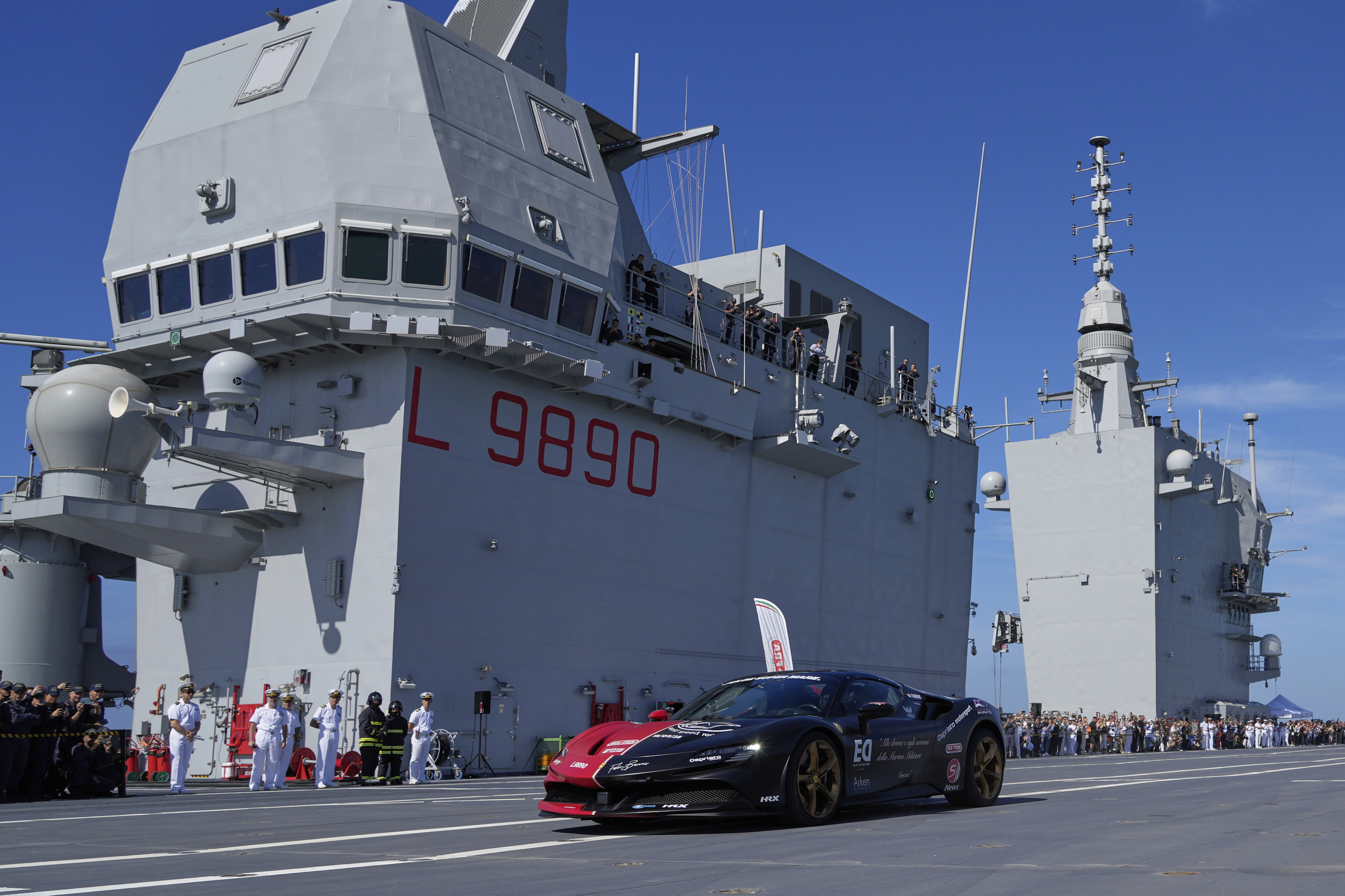 Italian driver Fabio Barone attempts to break his own speed record on a ship, at the wheel of a Ferrari SF 90, on the flight deck of the Italian Navy aircraft carrier Nave Trieste, docked at the port of Civitavecchia, Thursday, Sept. 18, 2025. 