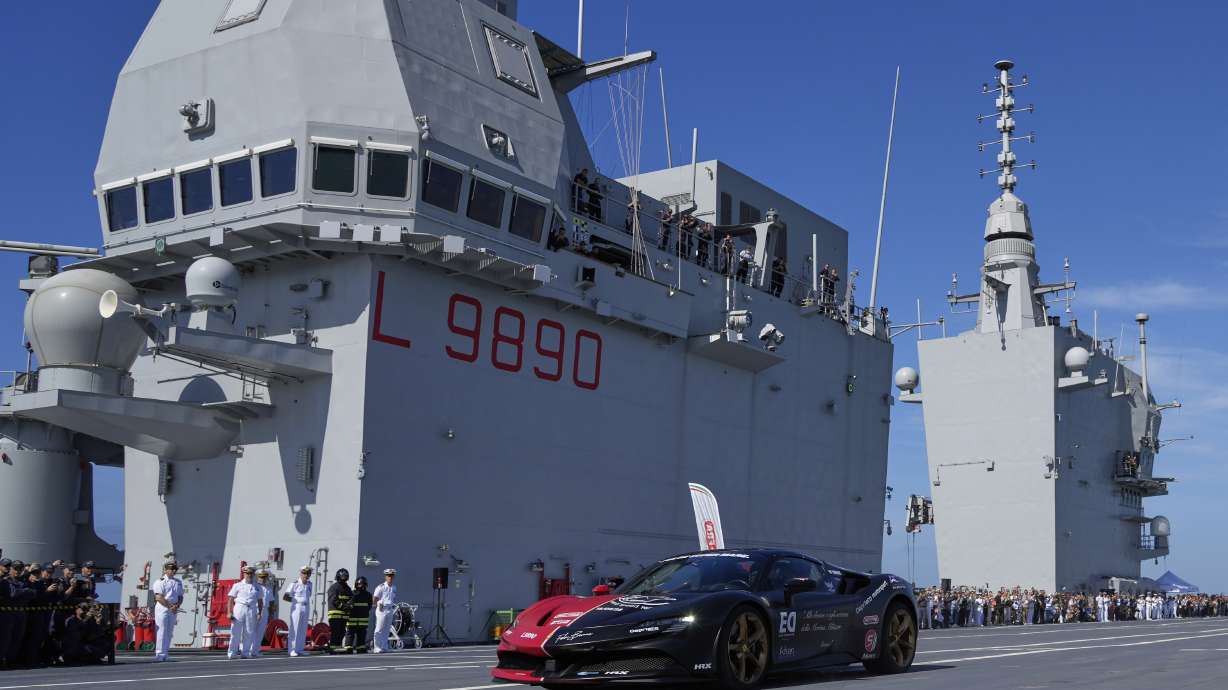 Italian driver Fabio Barone attempts to break his own speed record on a ship, at the wheel of a Ferrari SF 90, on the flight deck of the Italian Navy aircraft carrier Nave Trieste, docked at the port of Civitavecchia, Thursday, Sept. 18, 2025.
