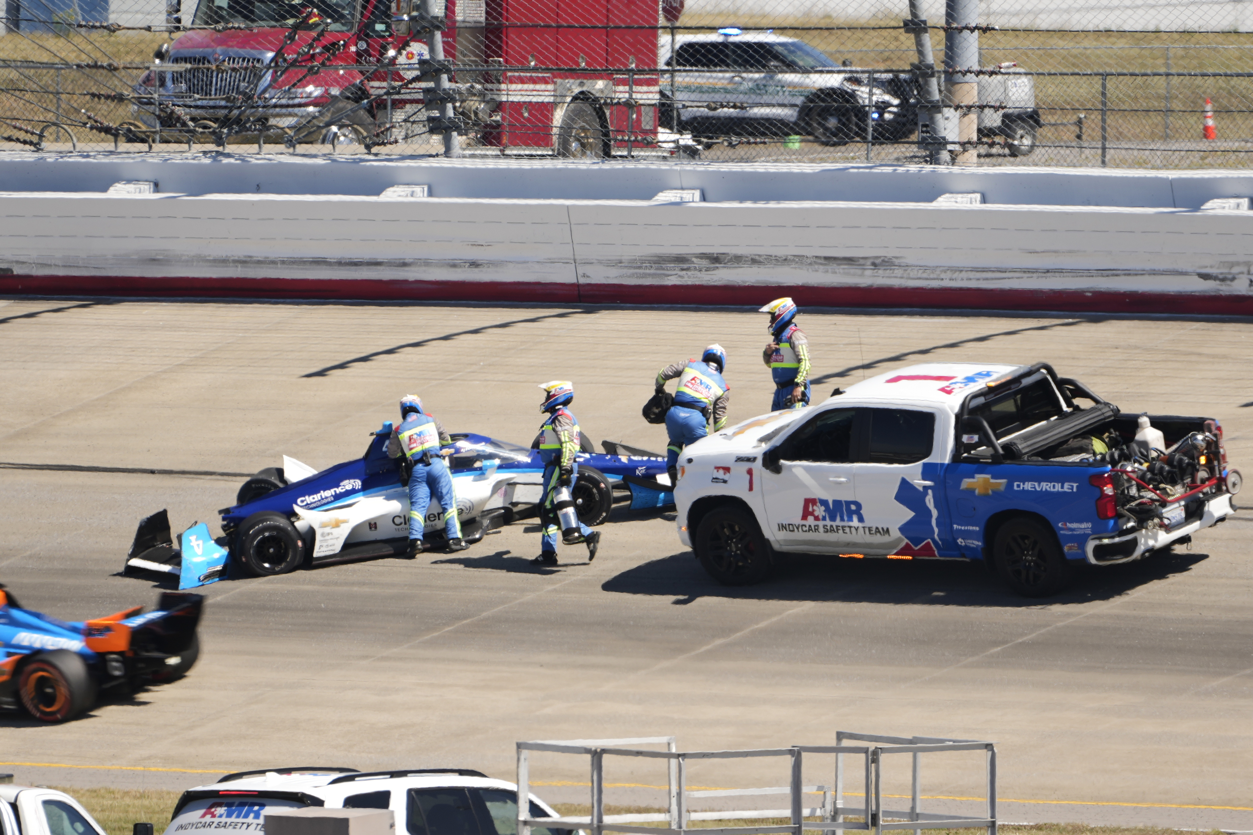 David Malukas (4) is helped by track personnel after his crash during an IndyCar auto race Sunday, Aug. 31, 2025, at Nashville Superspeedway in Lebanon, Tenn.