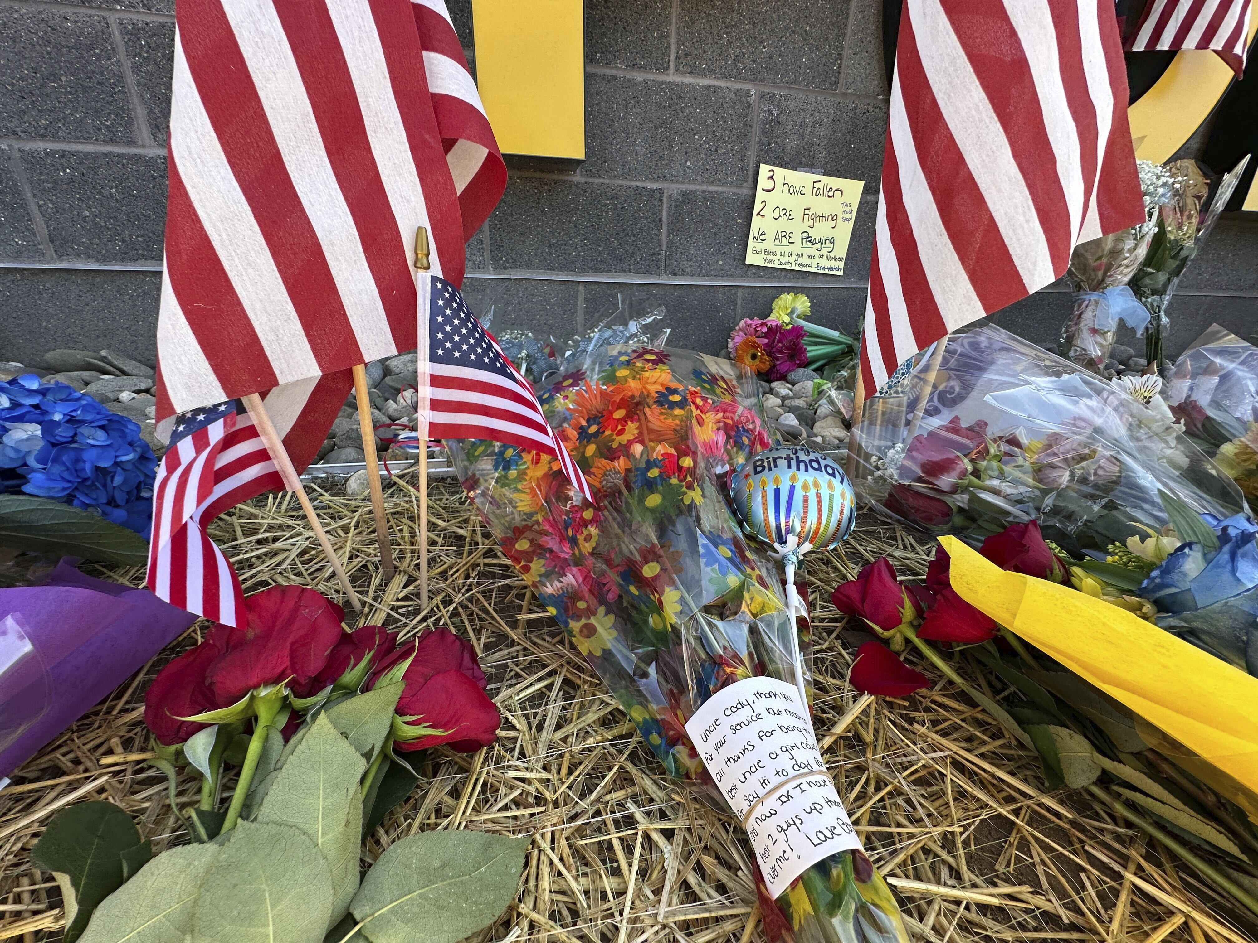 A memorial outside the Northern York County Regional Police Department, Thursday, in York, Pa. A suspected stalker armed with a rifle ambushed police officers who came to arrest him, killing three of them, authorities said.