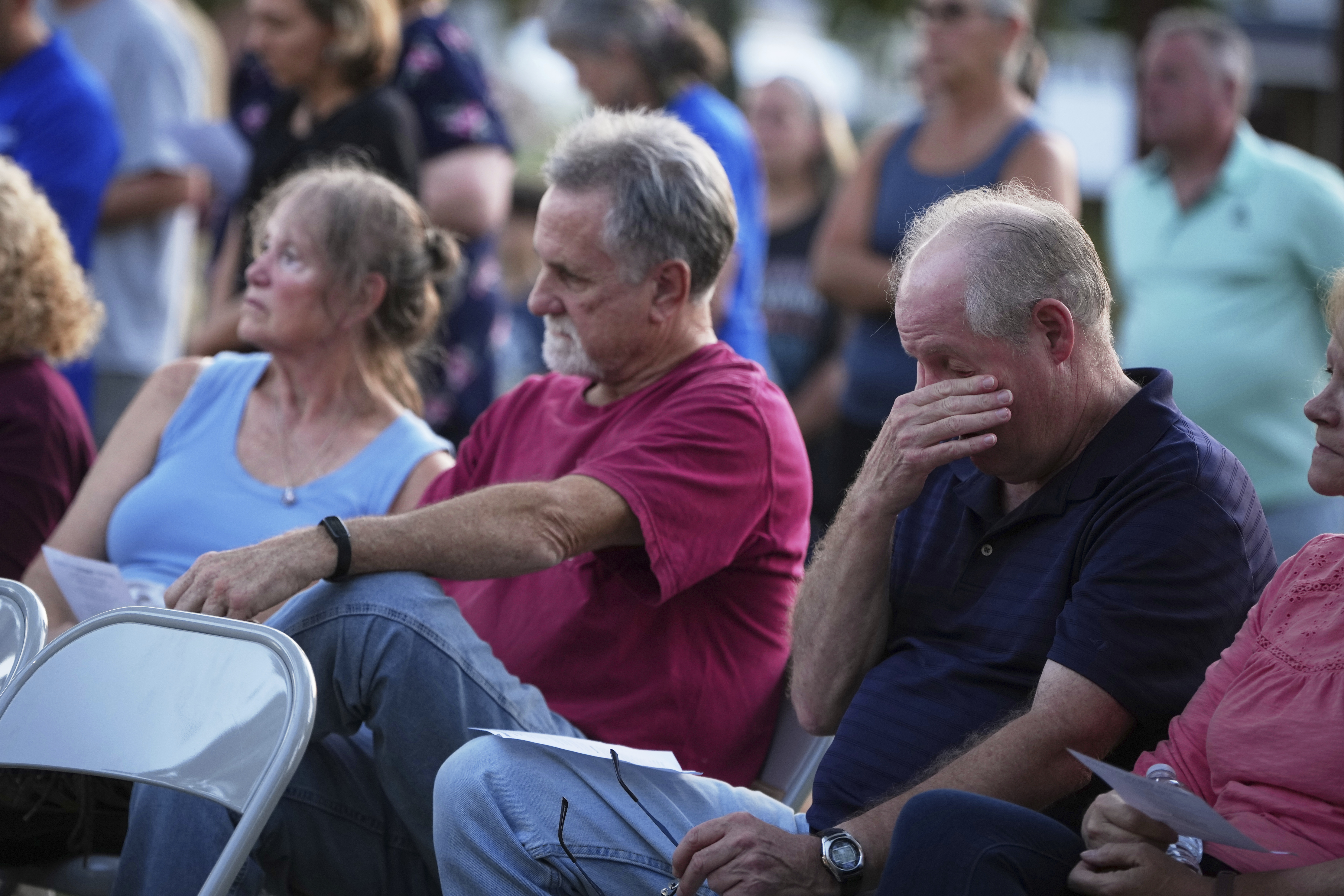 Attendees during a vigil at Spring Grove Alliance church Thursday, in Spring Grove, Pa. Community members left messages on stones for the victims, while pastors led prayers and hymns.
