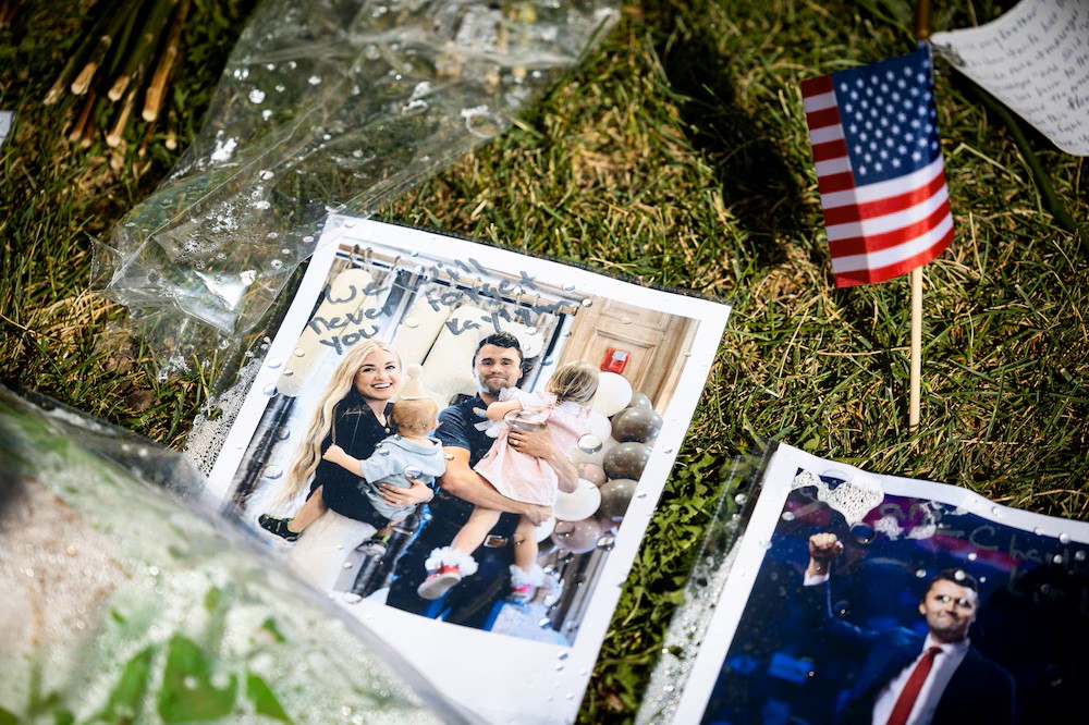 A photo of Charlie Kirk and his wife, Erika Kirk, with their children is displayed in a memorial left by well-wishers on the campus of Utah Valley University on Wednesday.
