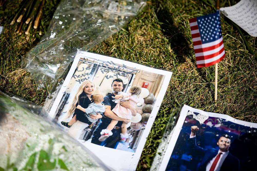 A photo of Charlie Kirk and his wife, Erika Kirk, with their children is displayed in a memorial left by well-wishers on the campus of Utah Valley University on Wednesday.