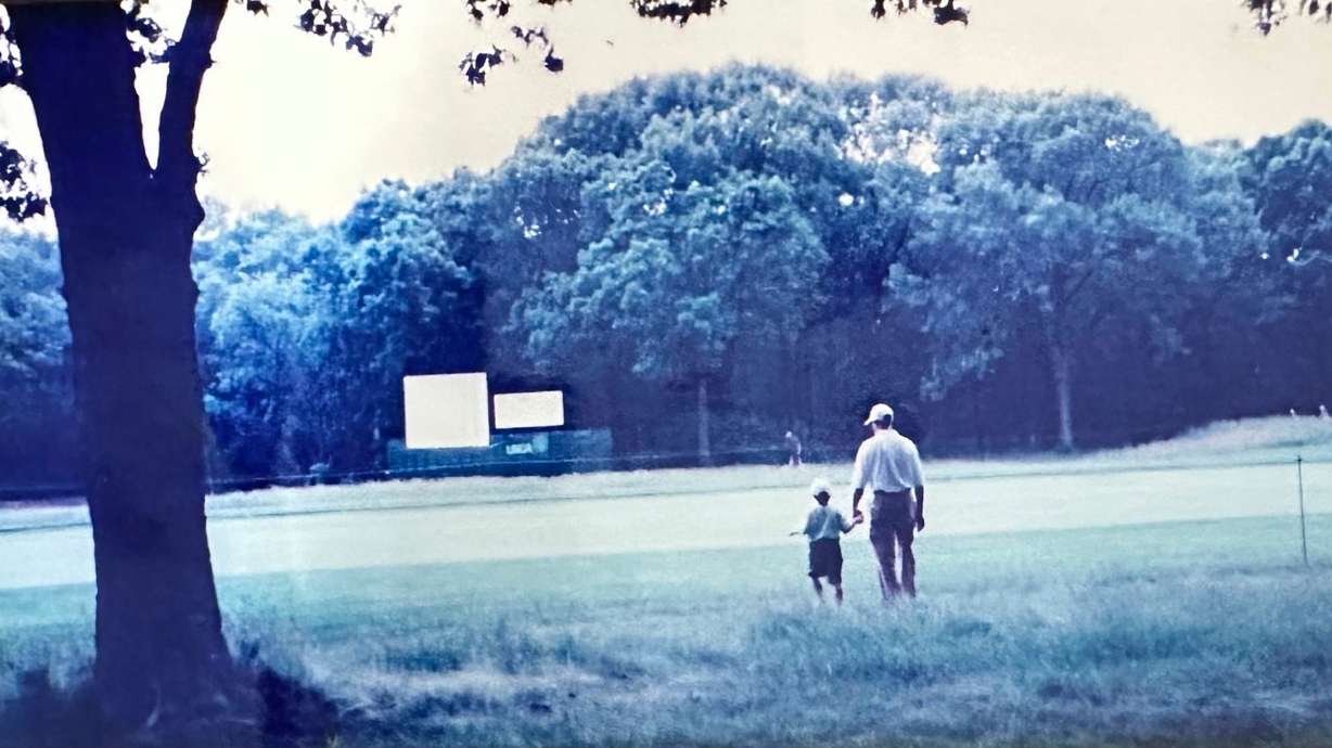 In this image provided by Barbara Young, Cameron Young, 5, holds his father's hand at Bethpage Black during the final round of the U.S. Open golf tournament, June 16, 2002, in Farmingdale, NY.