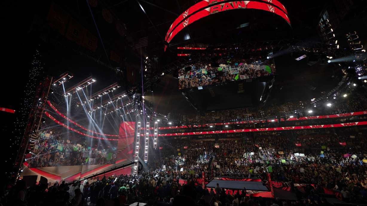 FILE - Bright lights illuminate the ring during the WWE Monday Night RAW event, Monday, March 6, 2023, in Boston.