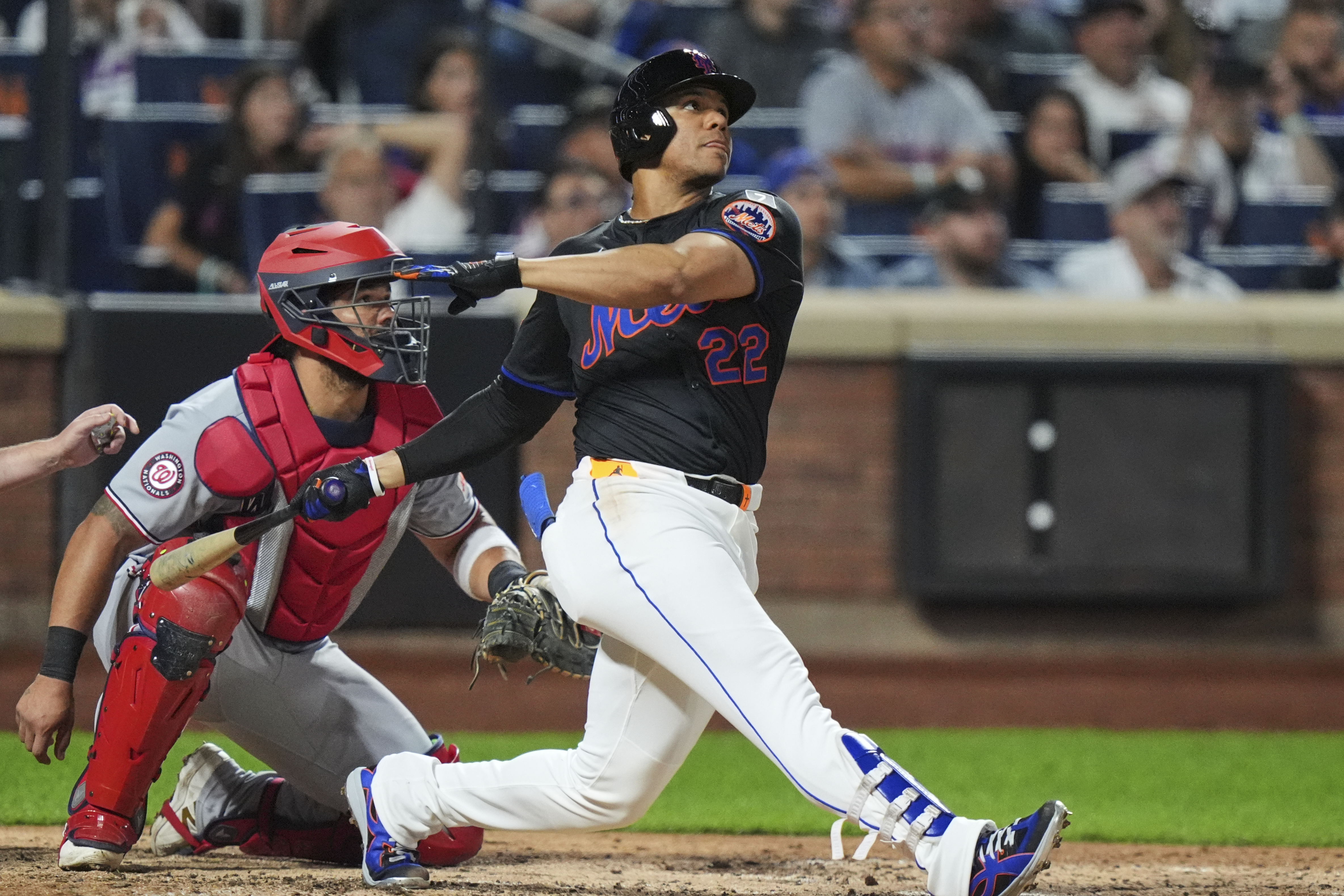 Washington Nationals catcher Jorge Alfaro, left, watches as New York Mets' Juan Soto hits a three-run home run during the fourth inning of a baseball game Friday, Sept. 19, 2025, in New York. 