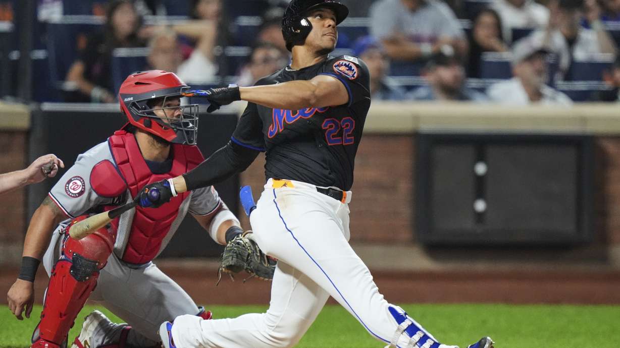 Washington Nationals catcher Jorge Alfaro, left, watches as New York Mets' Juan Soto hits a three-run home run during the fourth inning of a baseball game Friday, Sept. 19, 2025, in New York.