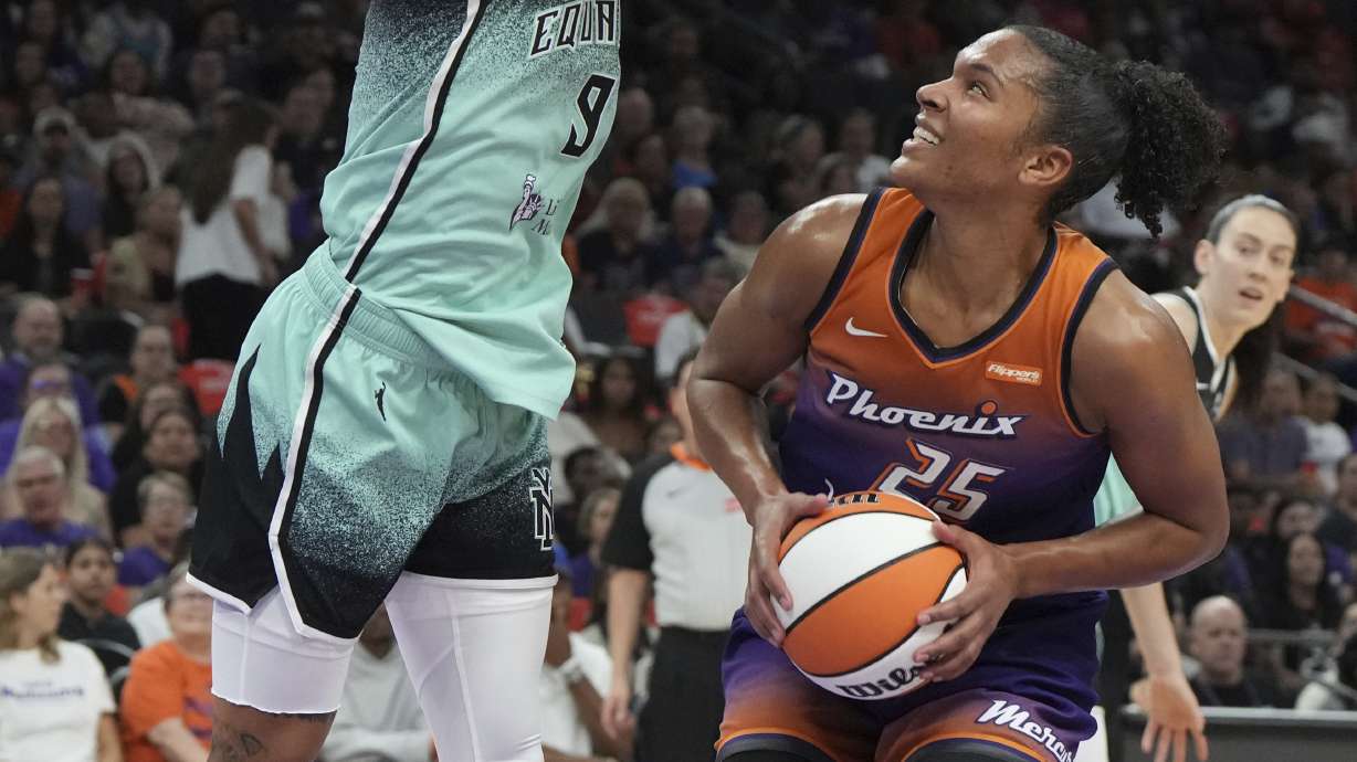 New York Liberty guard Natasha Cloud (9) defends against a shot by Phoenix Mercury forward Alyssa Thomas (25) during the first half of Game 3 in the first round of the WNBA basketball playoffs, Friday, Sept. 19, 2025, in Phoenix.