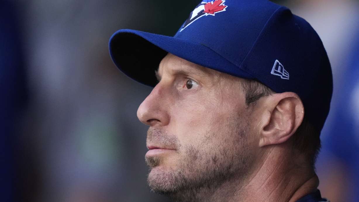 Toronto Blue Jays starting pitcher Max Scherzer watches from the dugout after coming out of the game during the first inning of a baseball game against the Kansas City Royals, Friday, Sept. 19, 2025, in Kansas City, Mo.